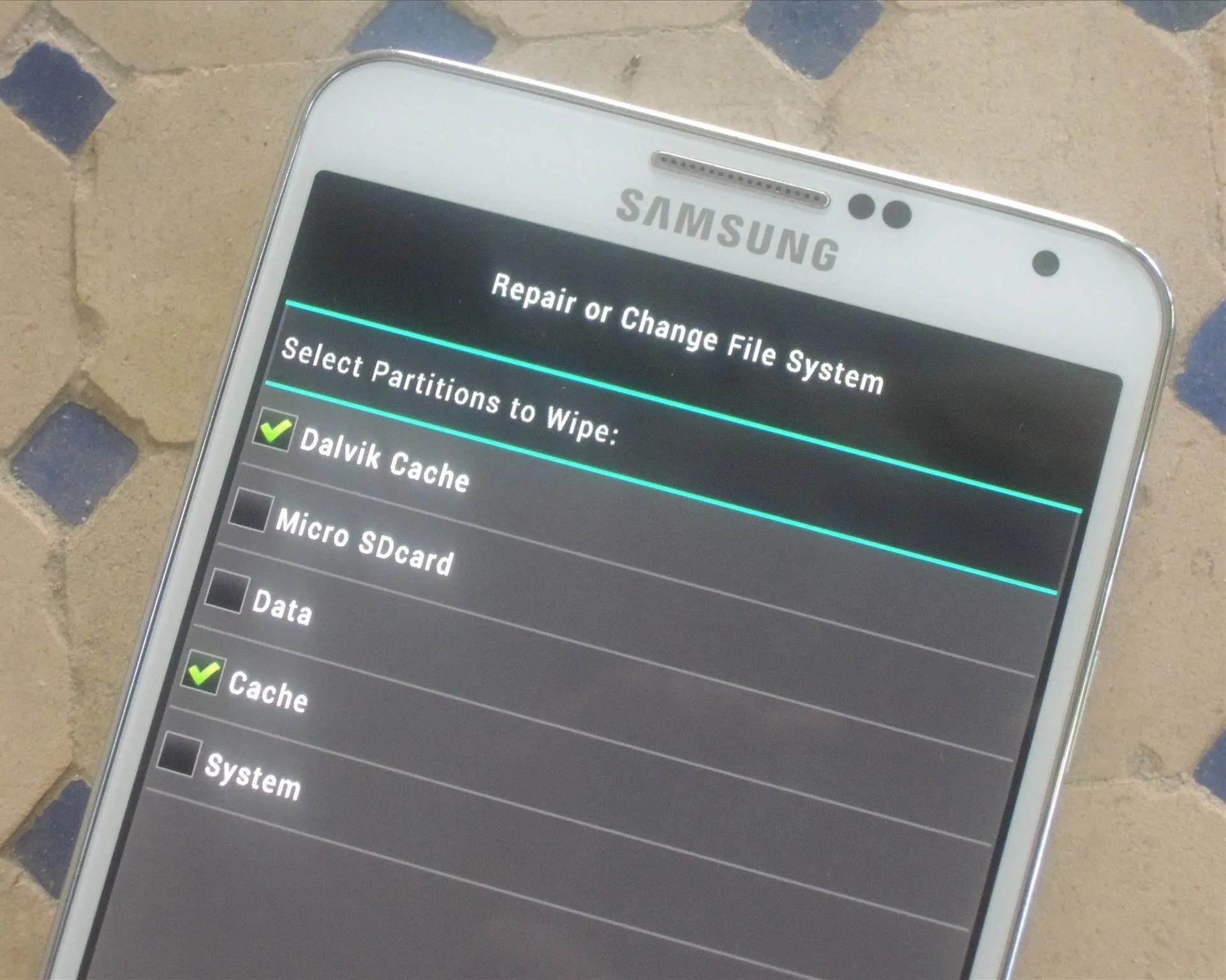 Samsung smartphone display showing repair or change file system options.