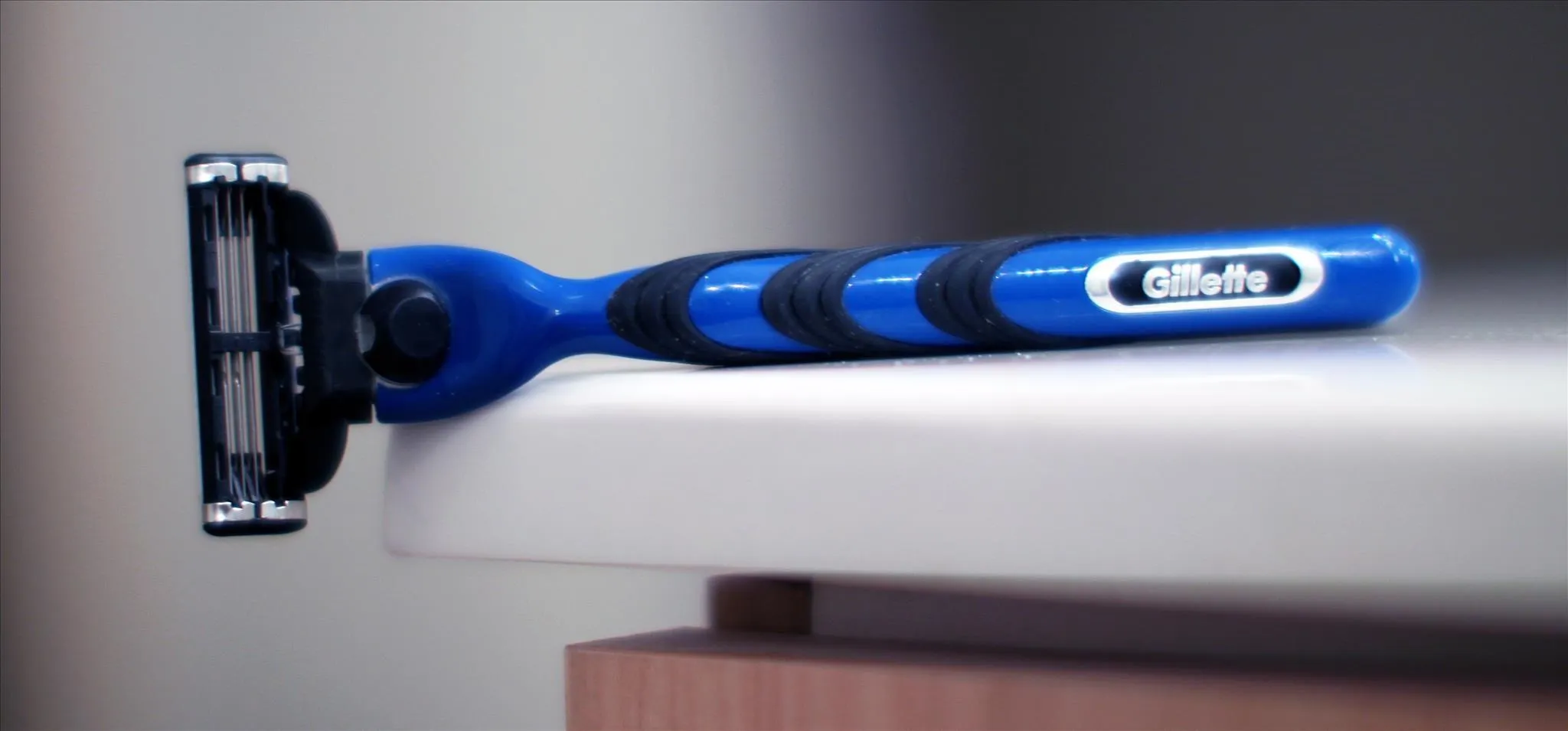 Blue razor on a white countertop.