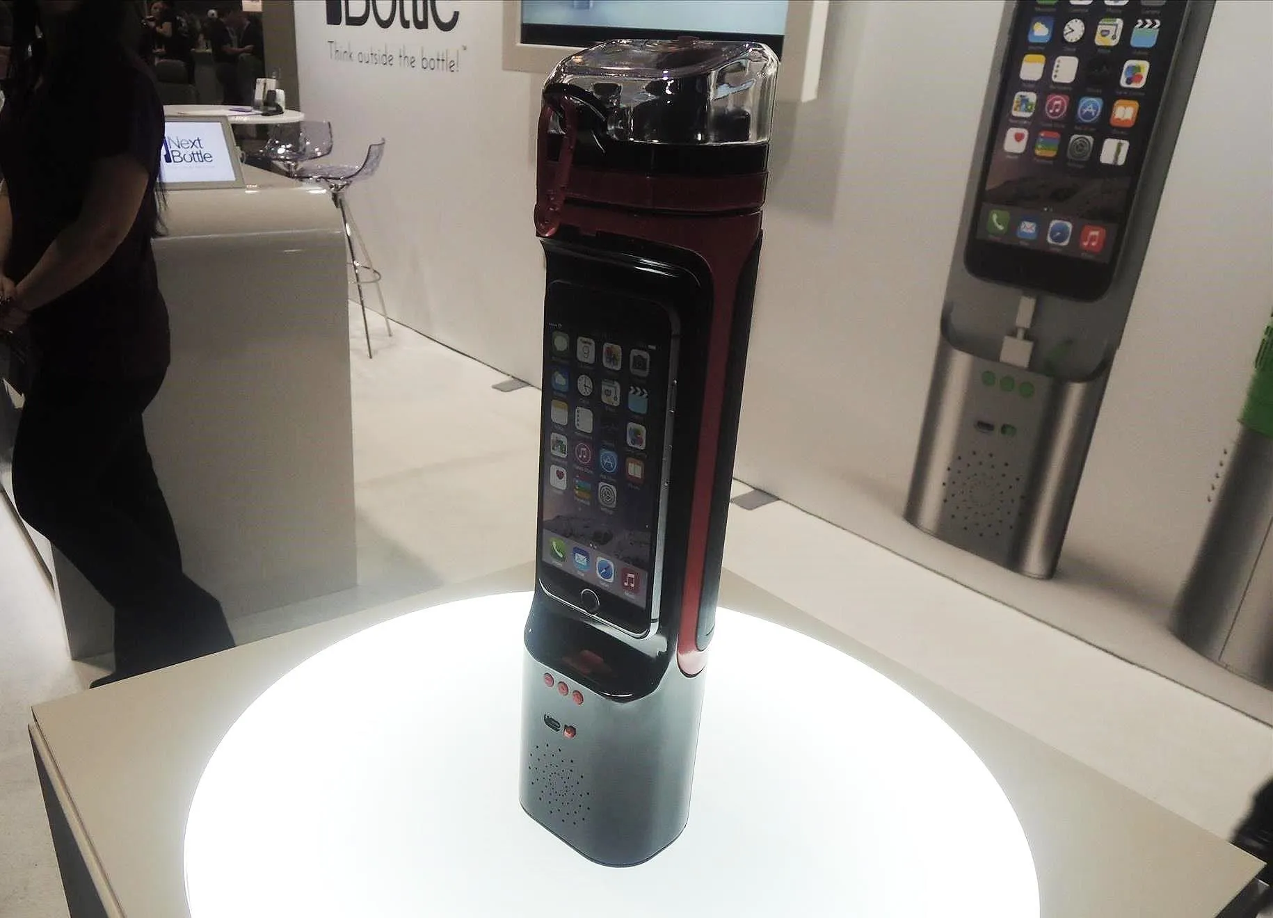 Smartphone displayed on a stand at a tech exhibition.