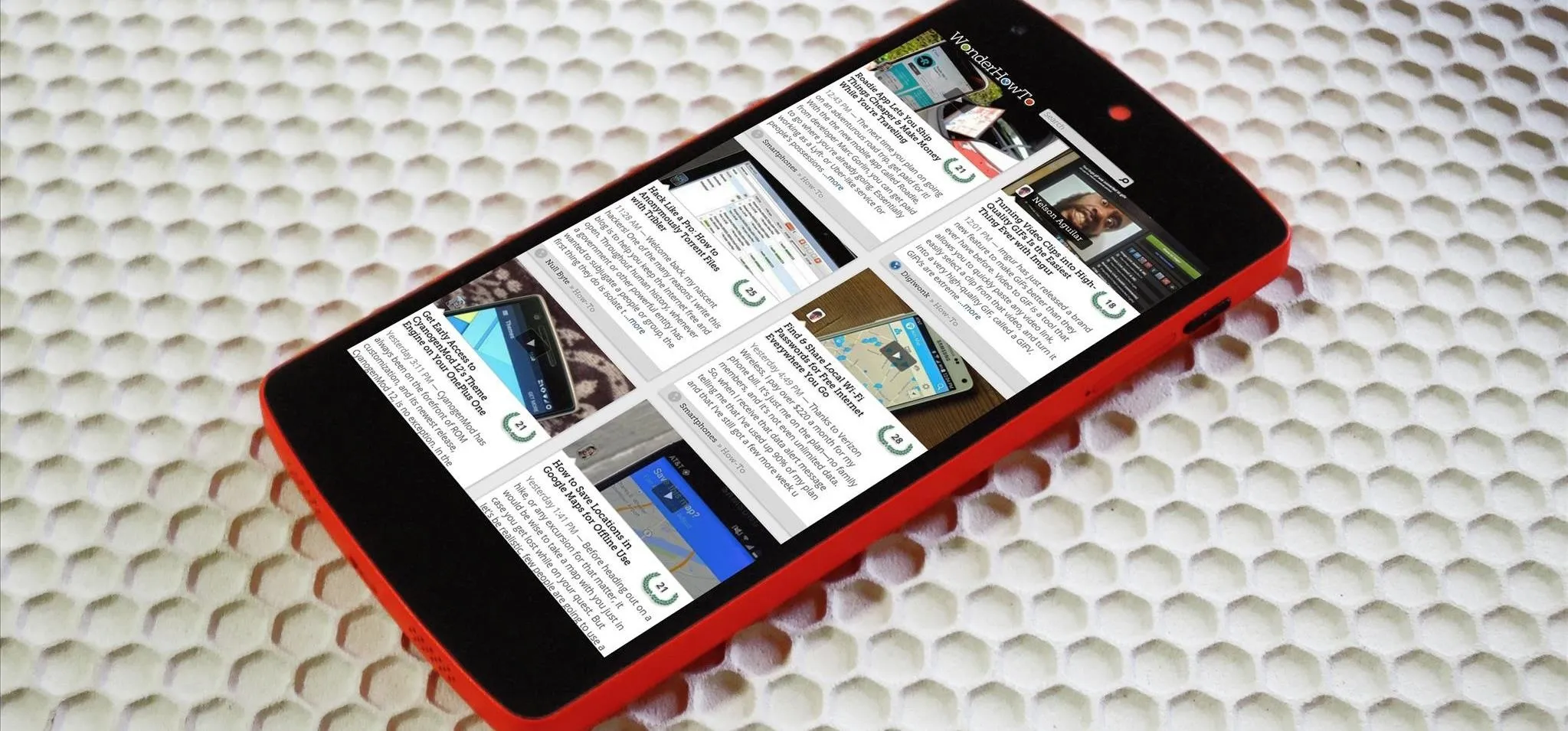 Smartphone displaying a collection of app thumbnails on a textured surface.