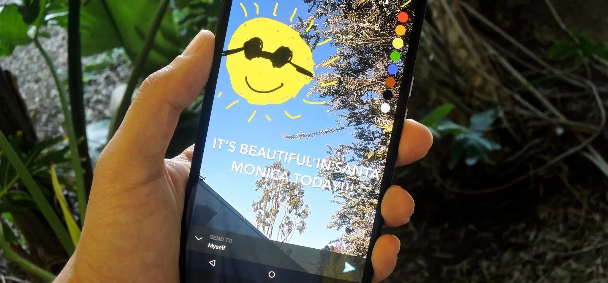 A hand holding a smartphone displaying a bright sun illustration and the text, "It's beautiful outside."