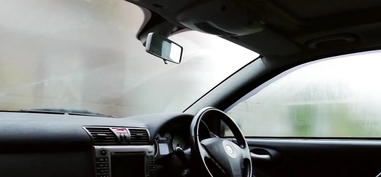 Car interior with fogged windshield.