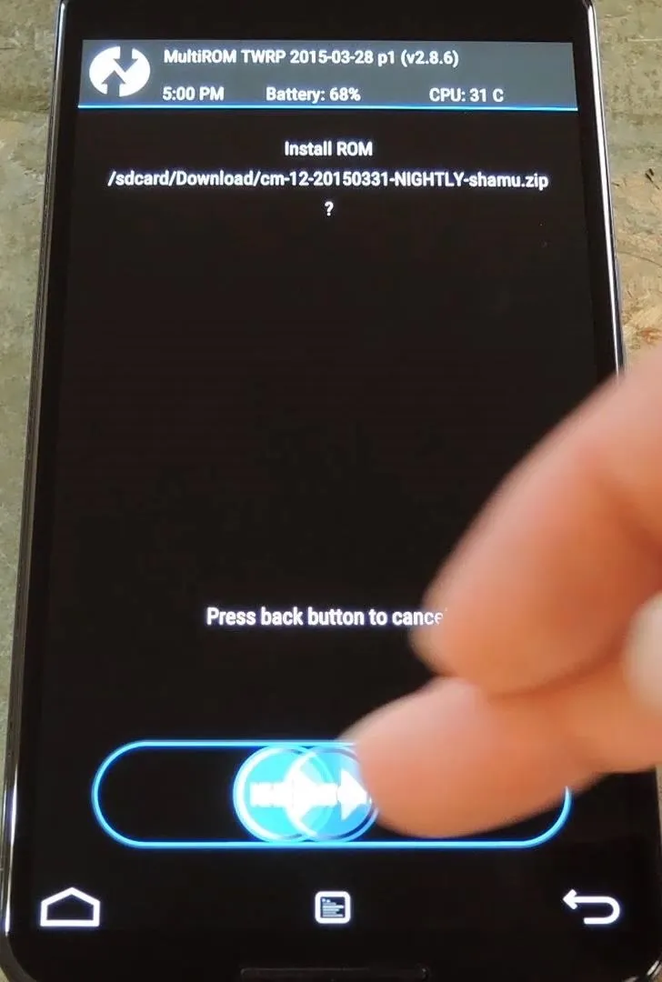 Finger pressing a button on a smartphone screen displaying an application interface.