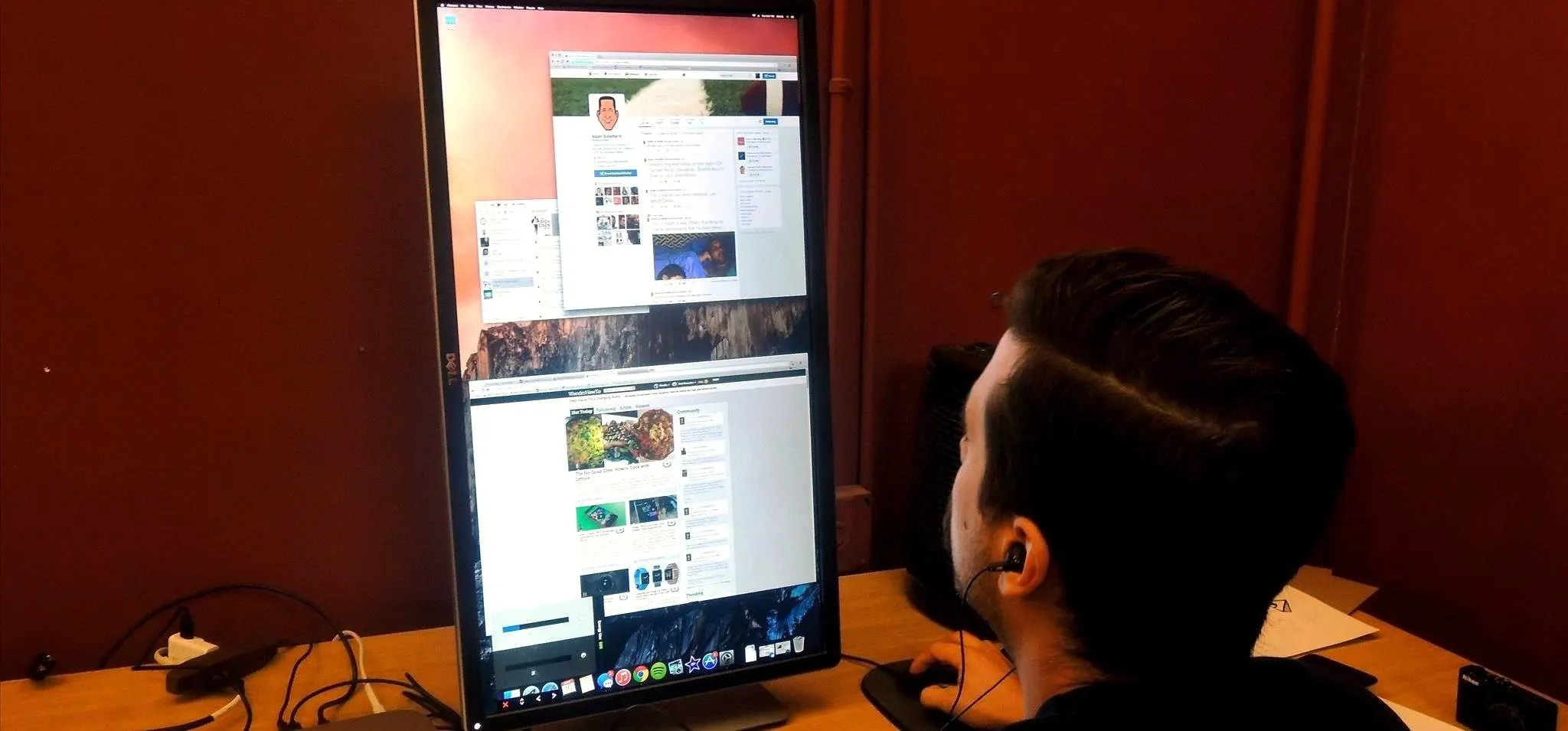 Person using a tall computer monitor to browse social media and websites.