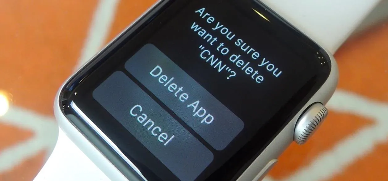 Smartwatch in a sleek white box on a wooden surface.