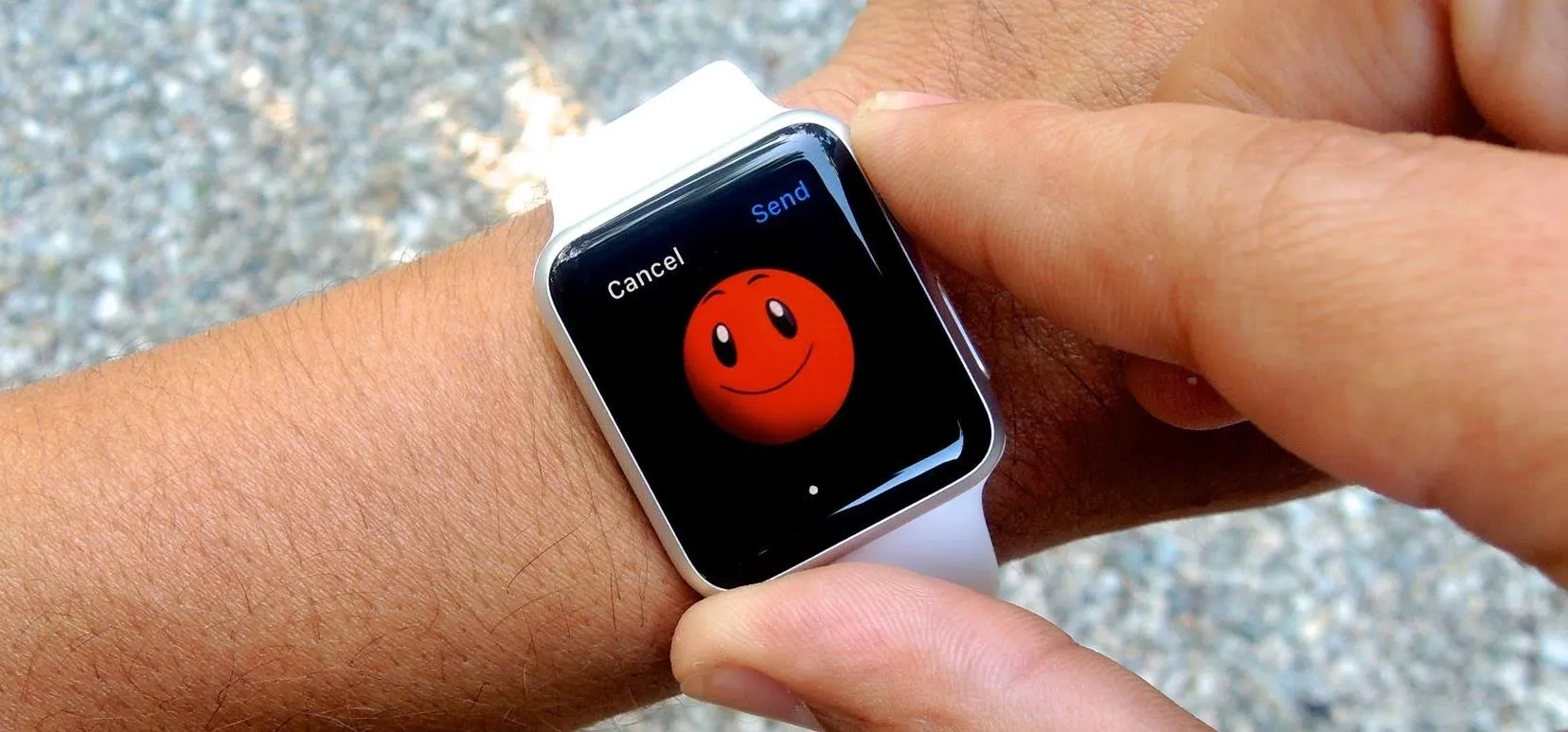 Smartwatch displaying a smiley face on its screen.