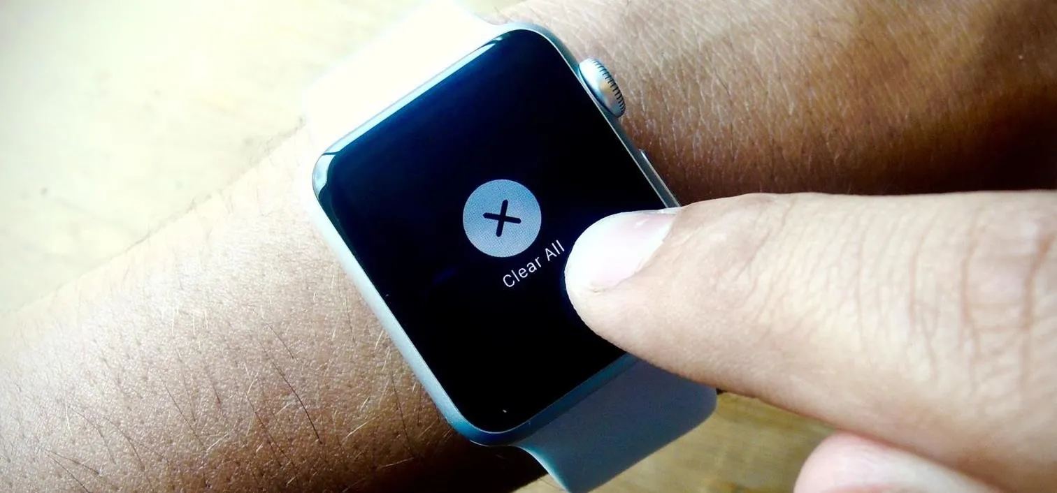 Smartwatch displaying a cancel button being pressed.