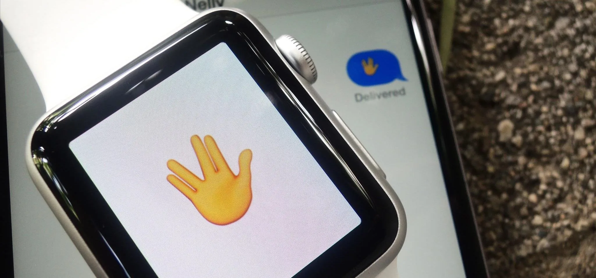 A smartwatch displaying a yellow hand emoji.