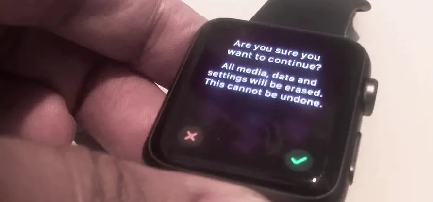 Smartwatch displaying a confirmation message about erasing data and settings.