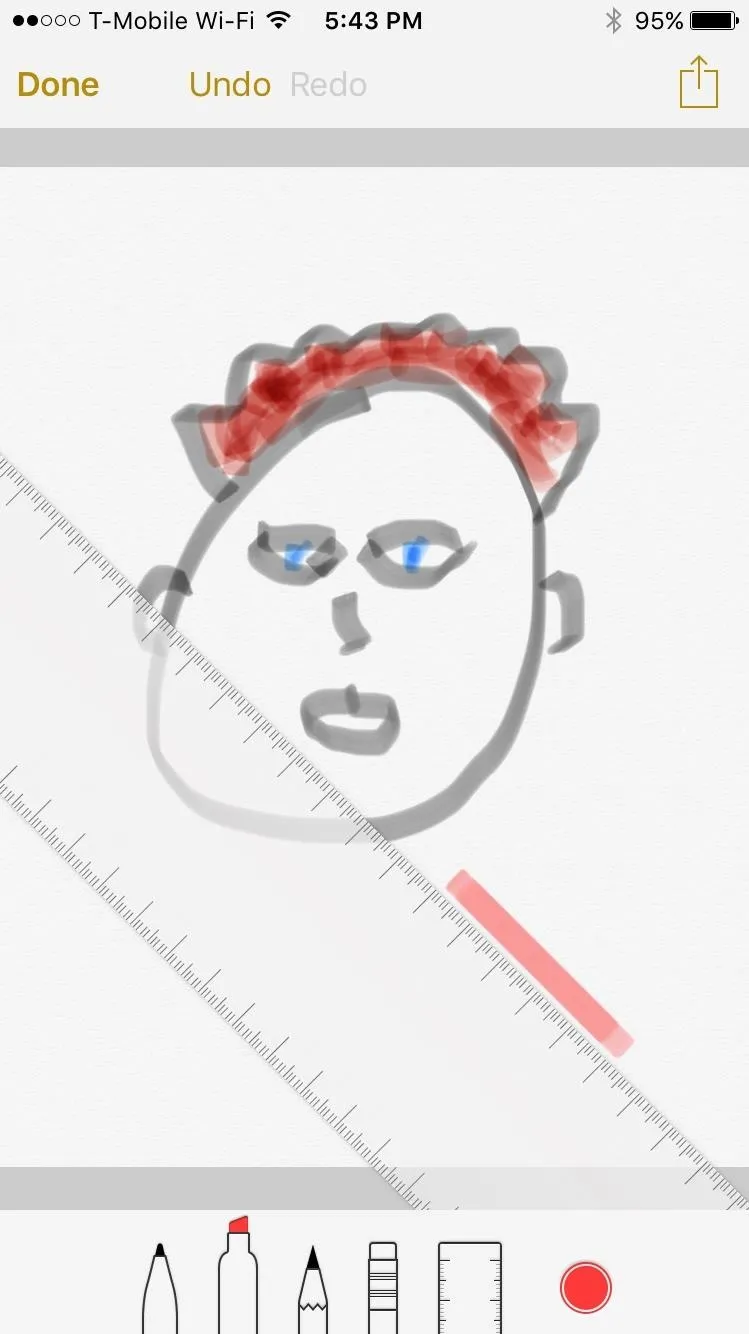 Child's drawing of a head with red hair and blue eyes.