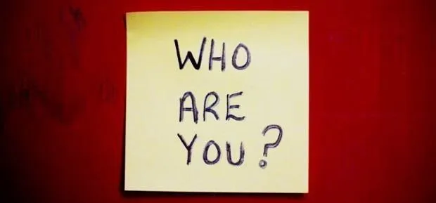 Sticky note with the text "Who Are You?" on a red background.