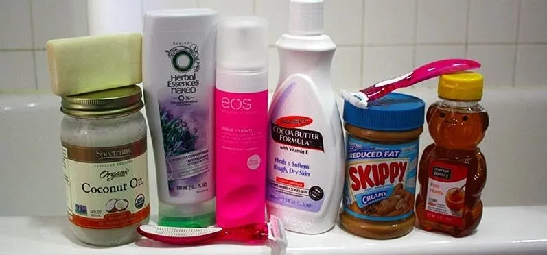 Collection of personal care and food products on a bathroom shelf.