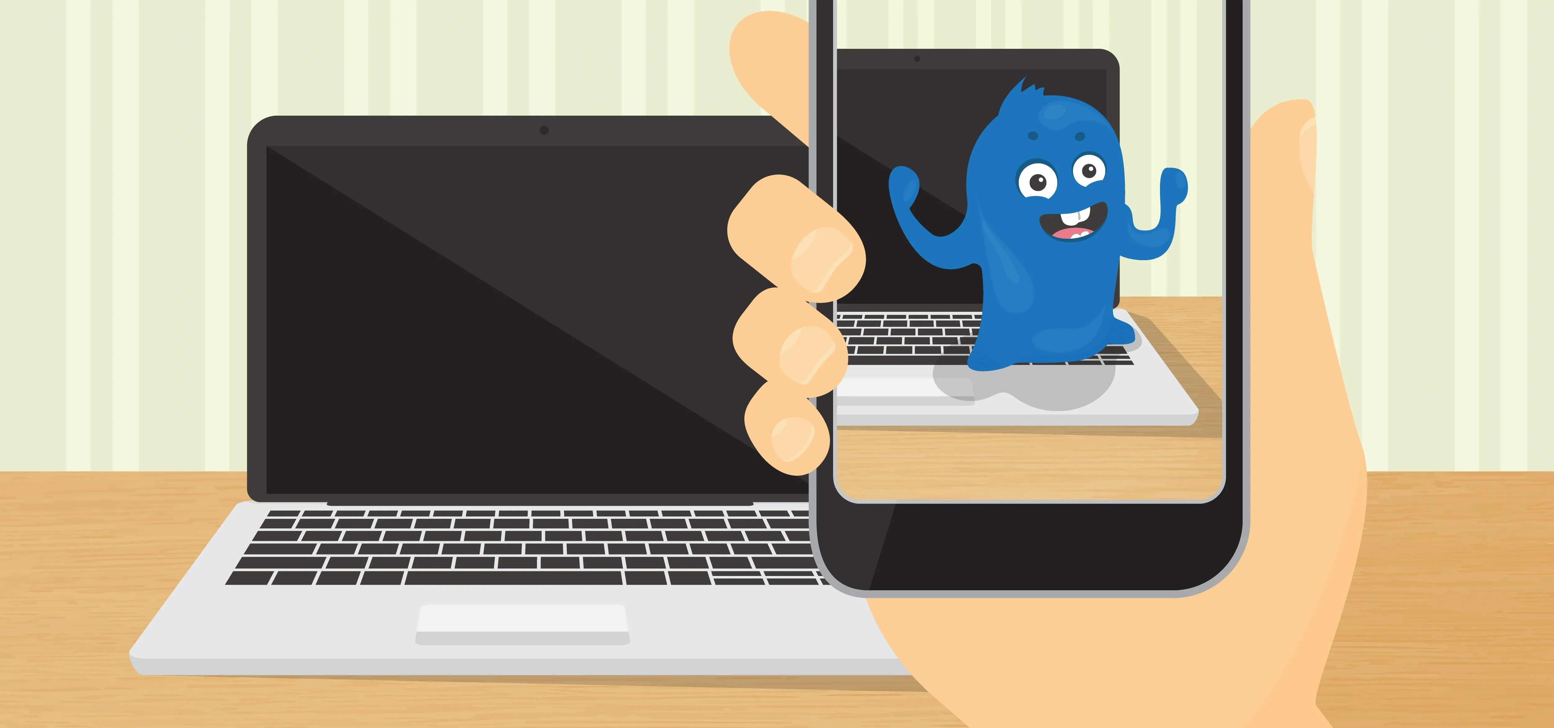 A person holding a smartphone capturing an image of a cartoon character in front of a laptop.