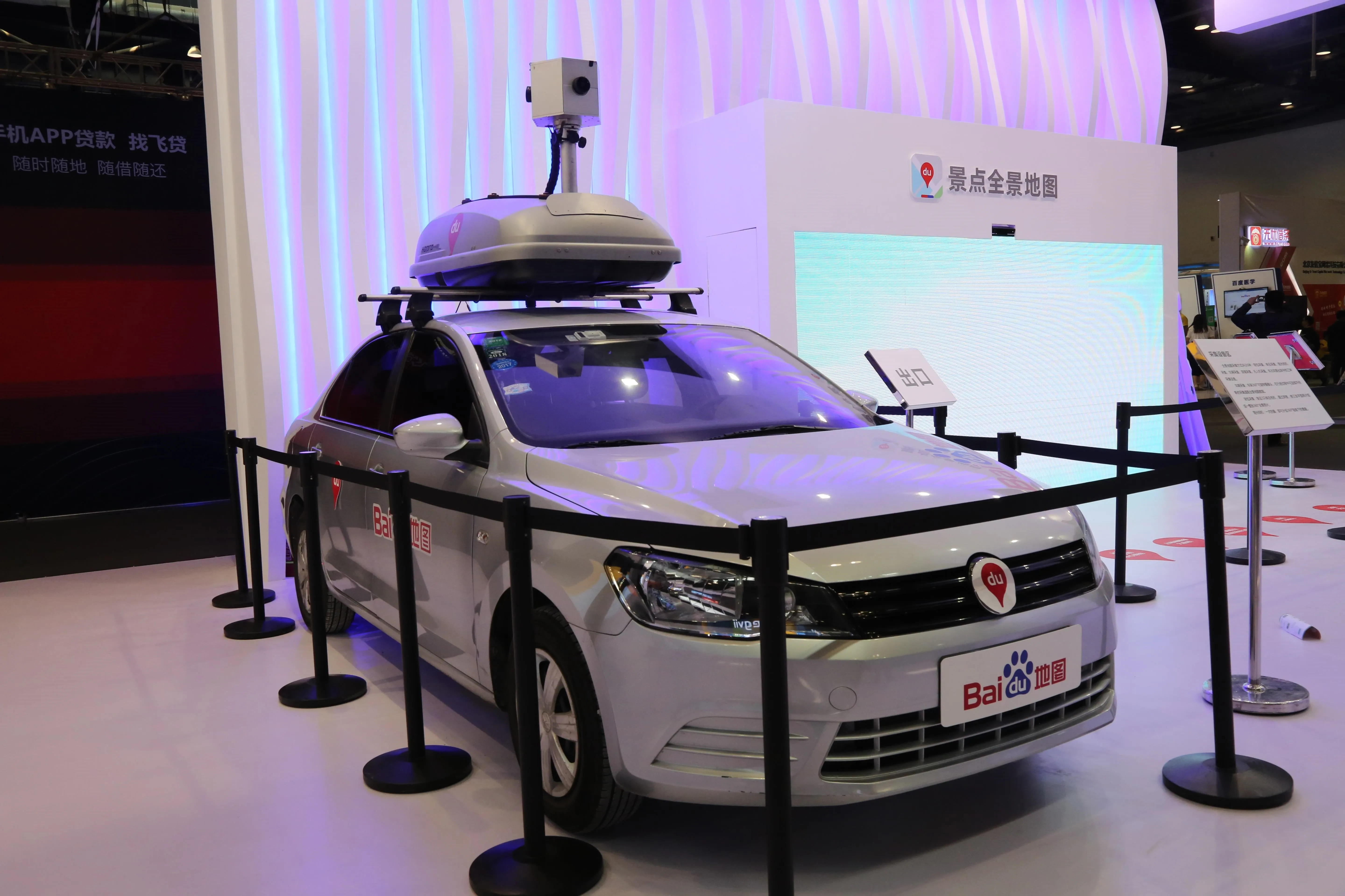 Self-driving car equipped with mapping technology at an auto show.