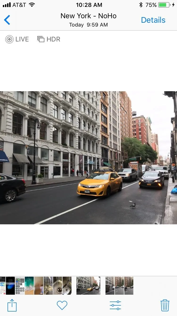 Yellow taxi driving through an urban street in New York City.