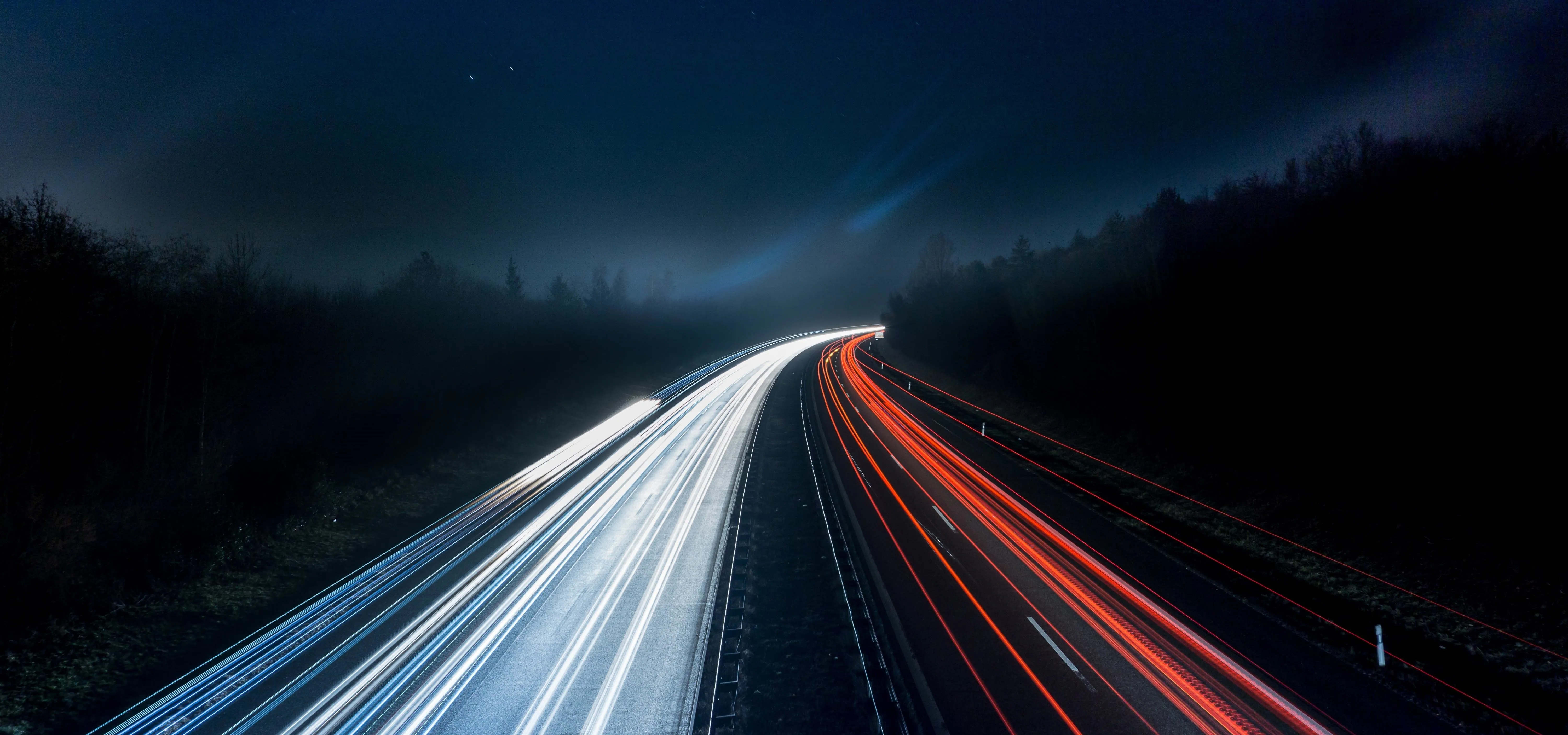 Light trails on a dark highway at night.