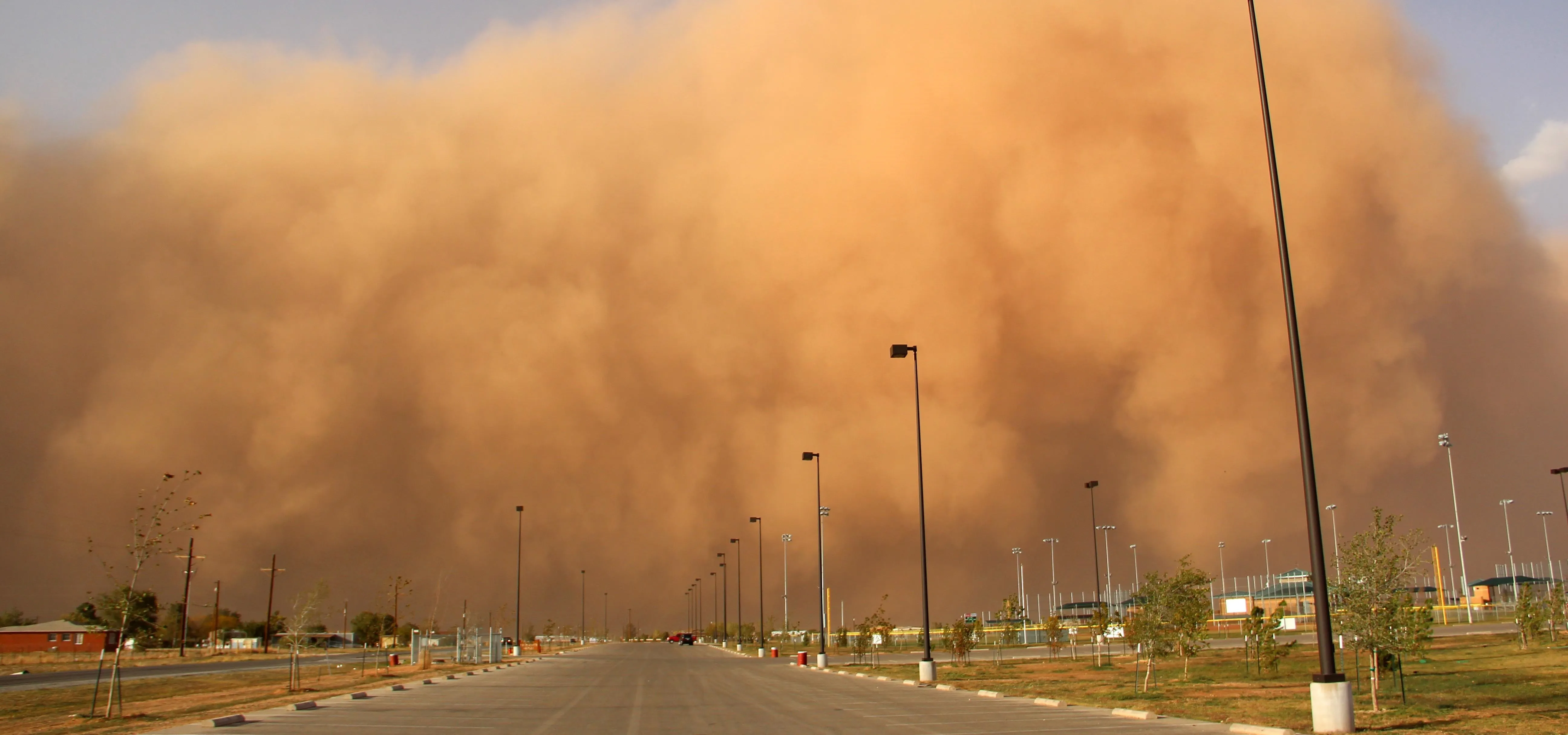 Dust storm approaching a road.