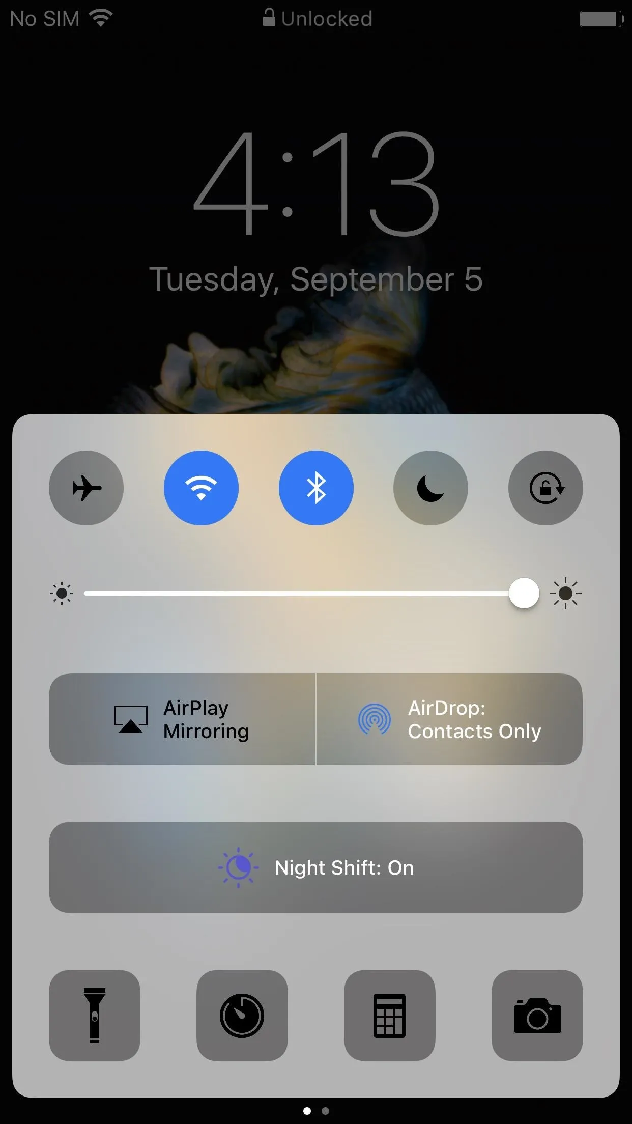 Mobile device screen displaying the control center with various settings and notifications.