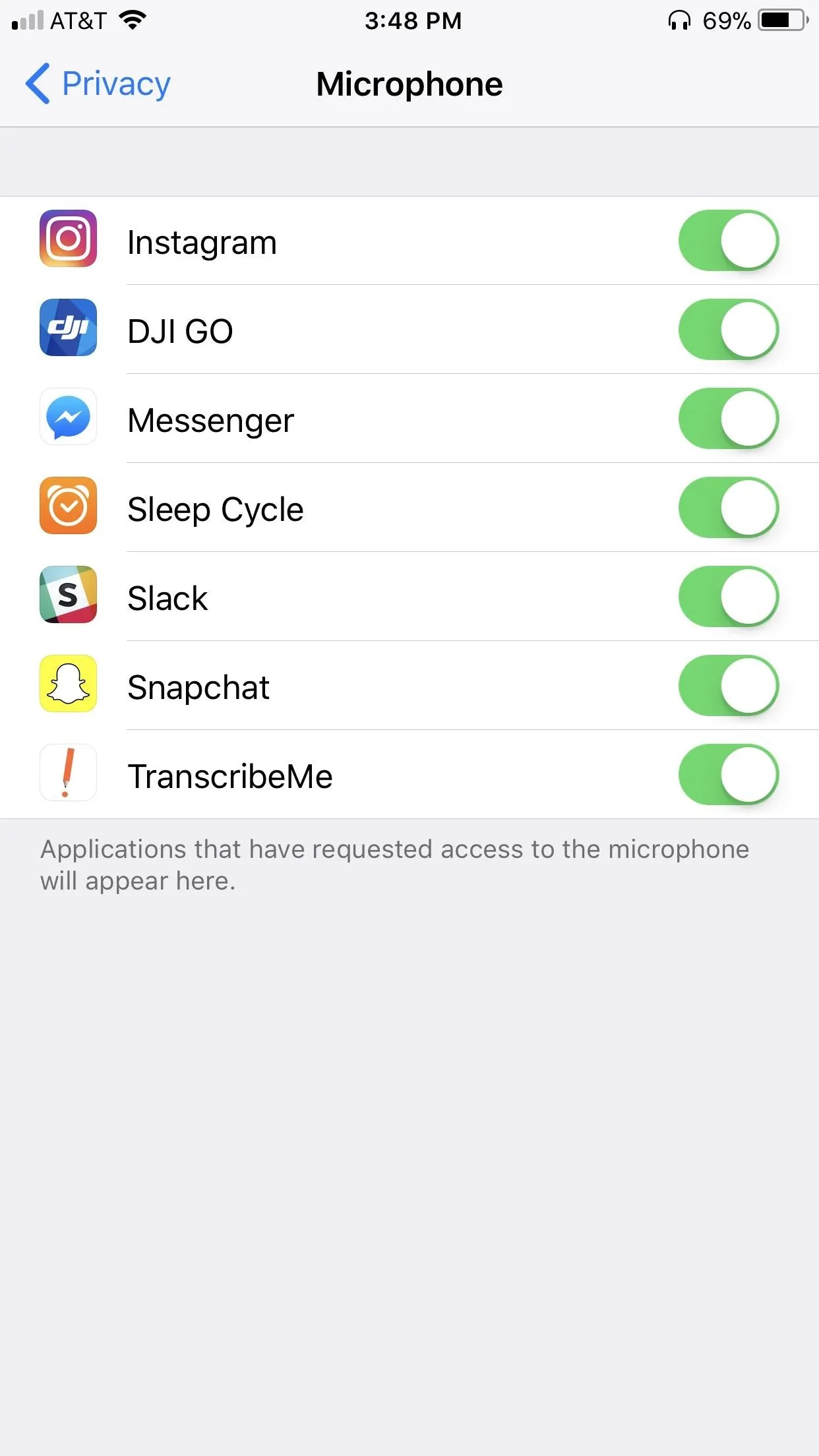 Microphone settings on a mobile device showing app permissions.