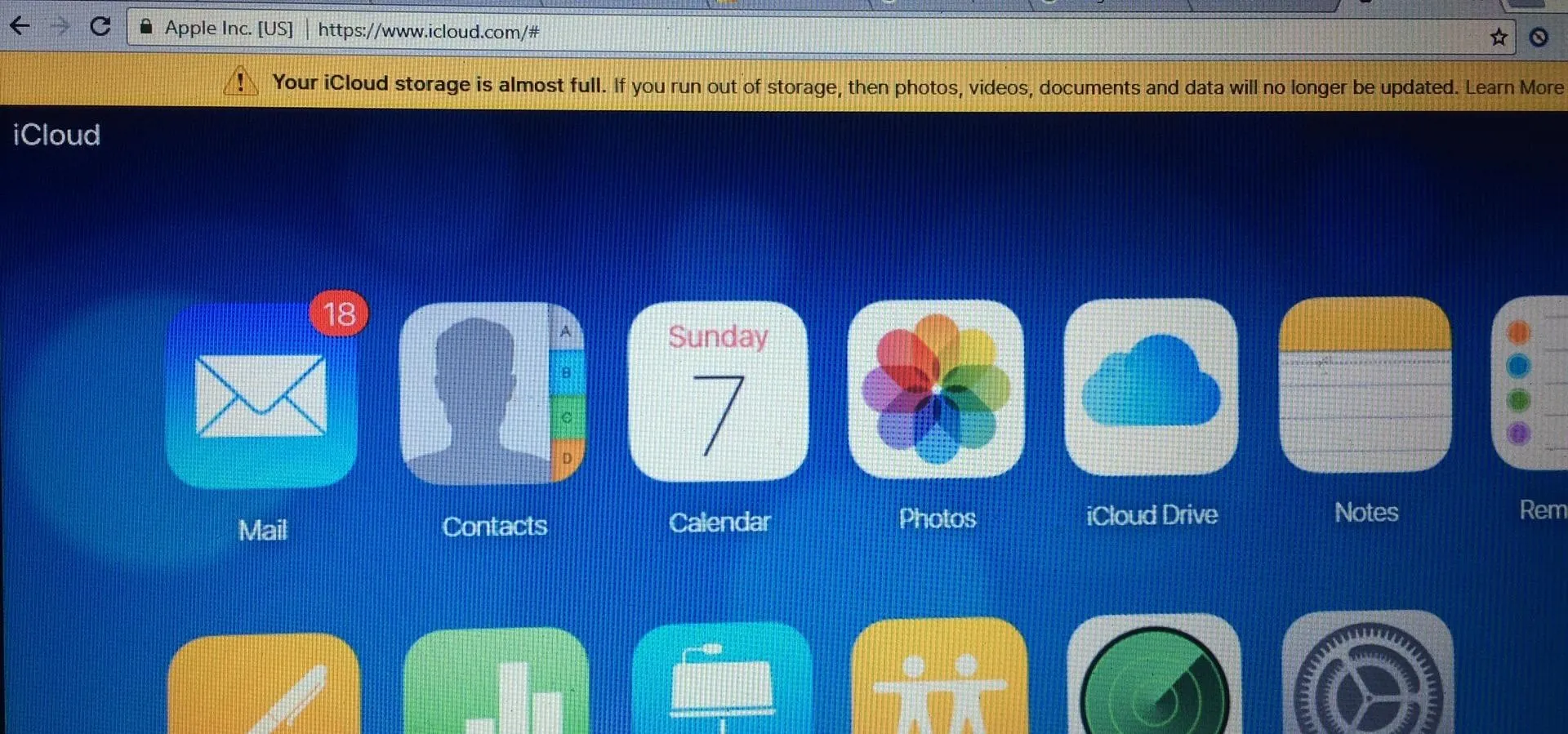 iCloud interface displaying various app icons including Mail, Contacts, Calendar, Photos, and iCloud Drive.
