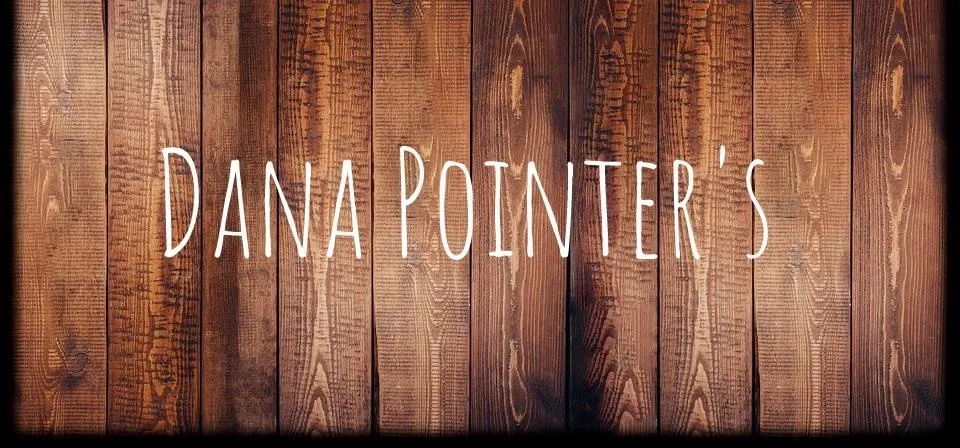 Dana Pointer's logo on a wooden background.