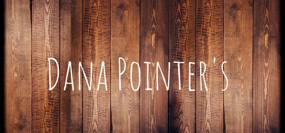 Dana Pointer's logo on a wooden background.