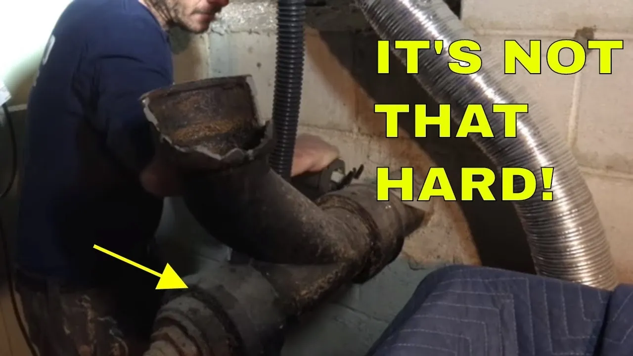 Person working on a plumbing issue with a pipe in focus.