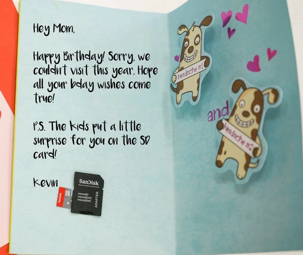 Greeting card with a birthday message for mom, featuring cartoon dogs and a small memory card.