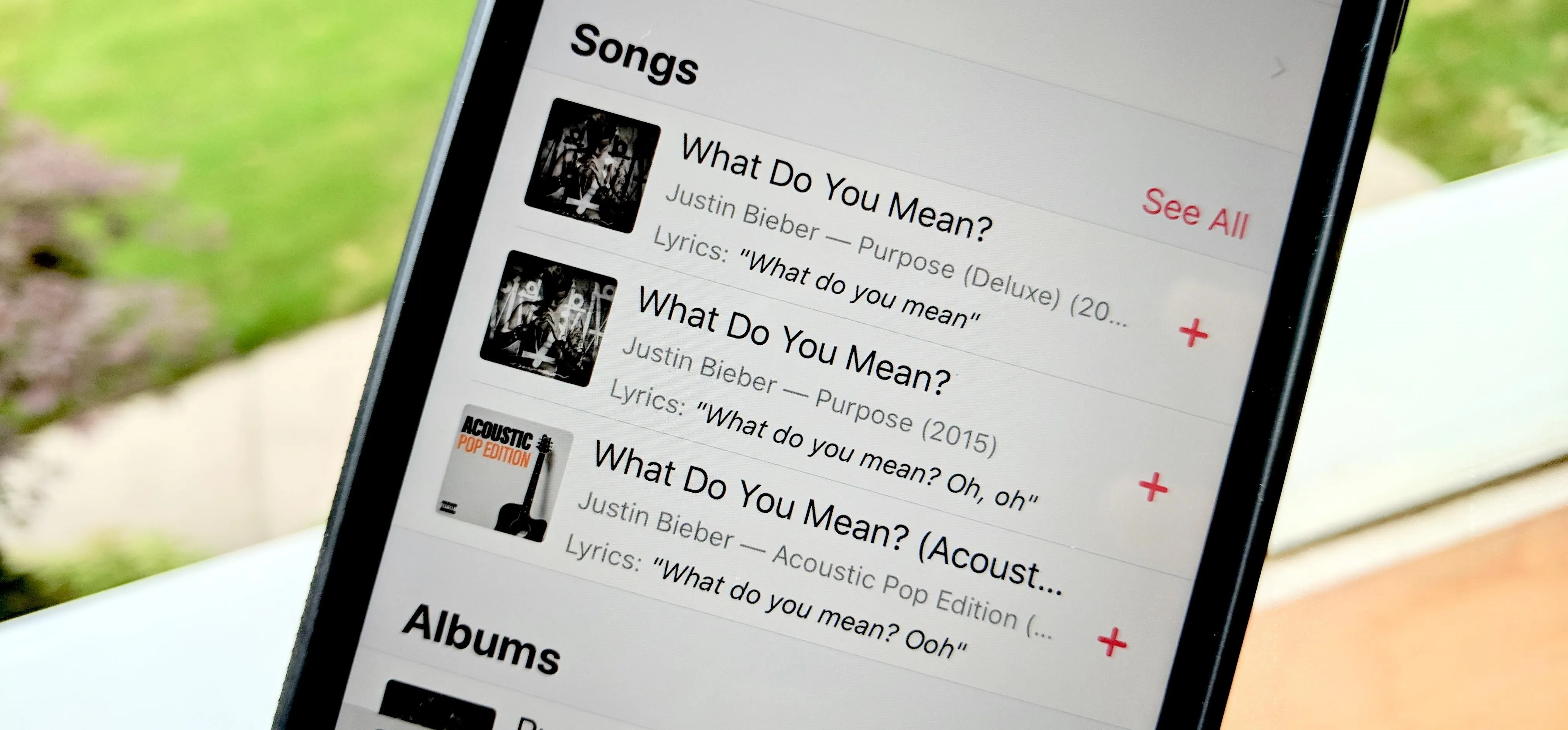 Music app interface displaying song titles and album information.