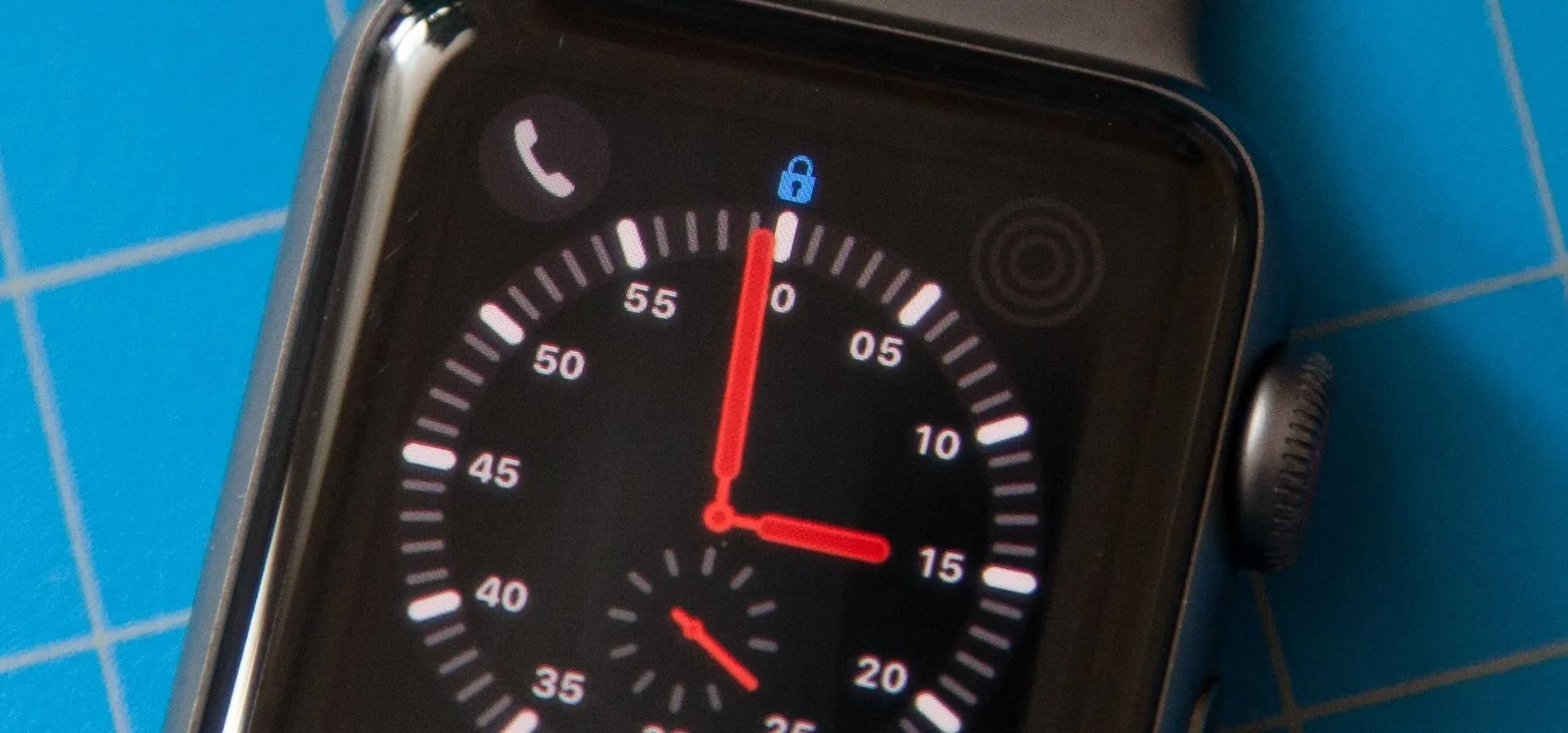 Smartwatch display showing time, phone icon, and a lock symbol.