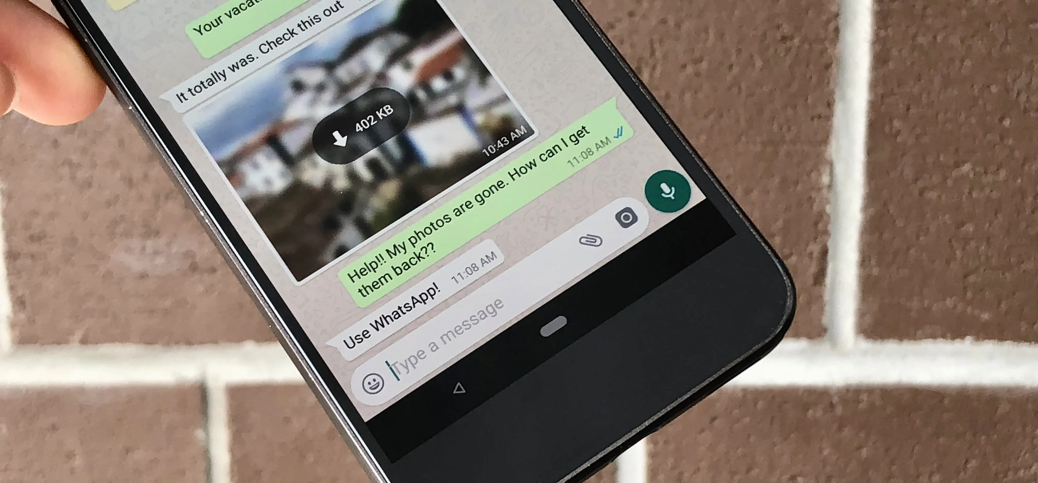 Smartphone displaying a WhatsApp conversation with an image attachment.