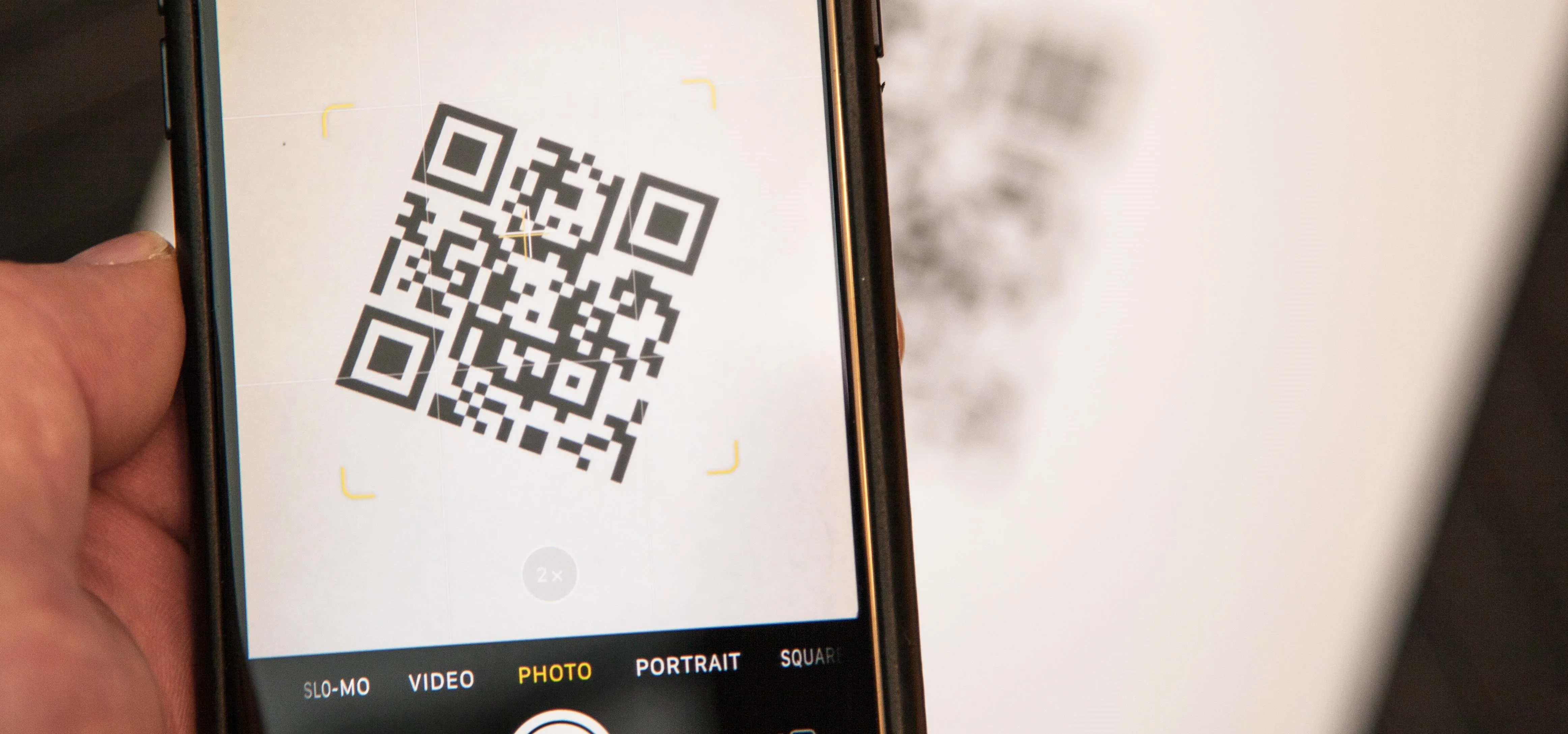 QR code being scanned with a smartphone.