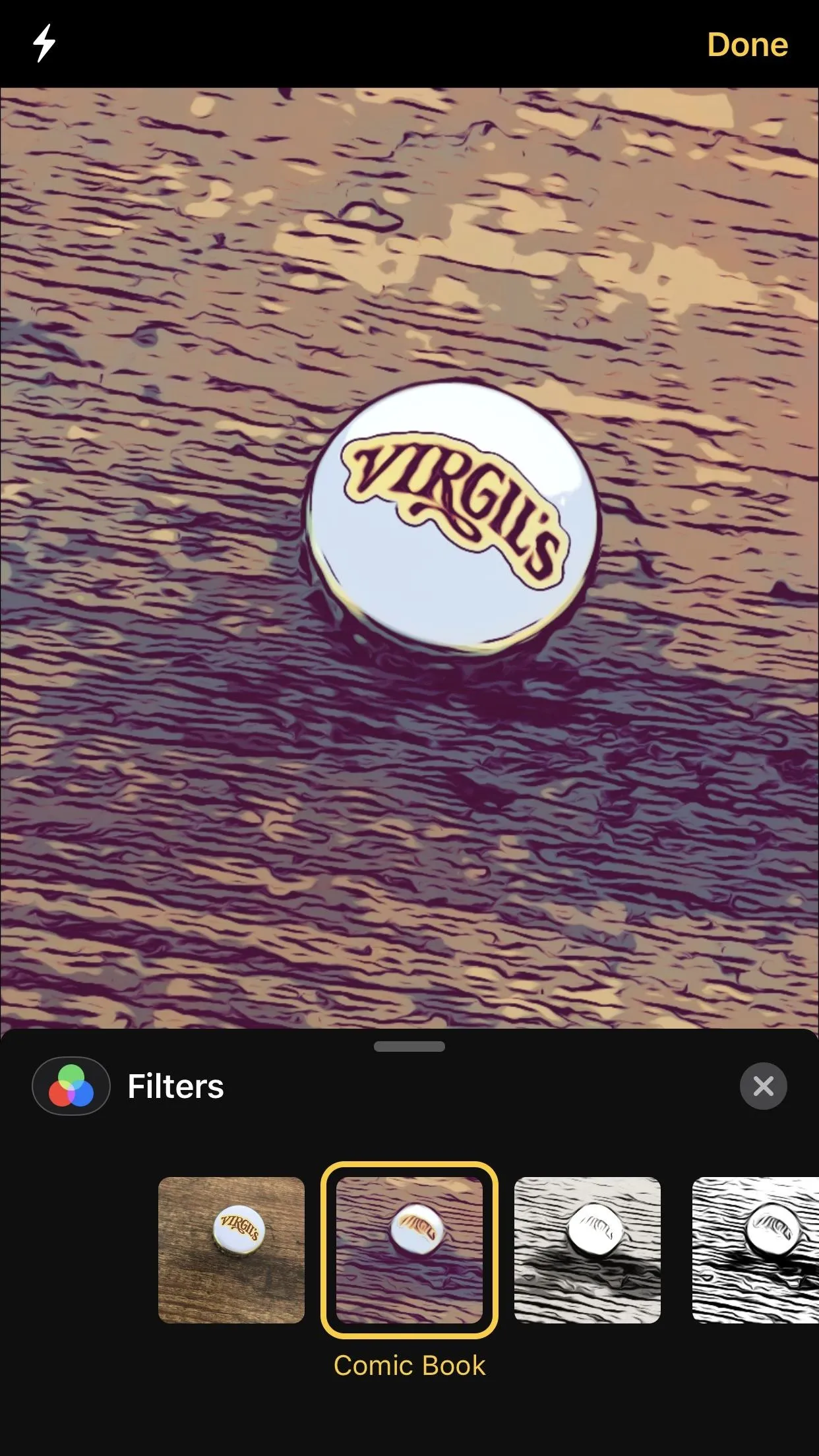 Vikings logo pin on a wooden surface.