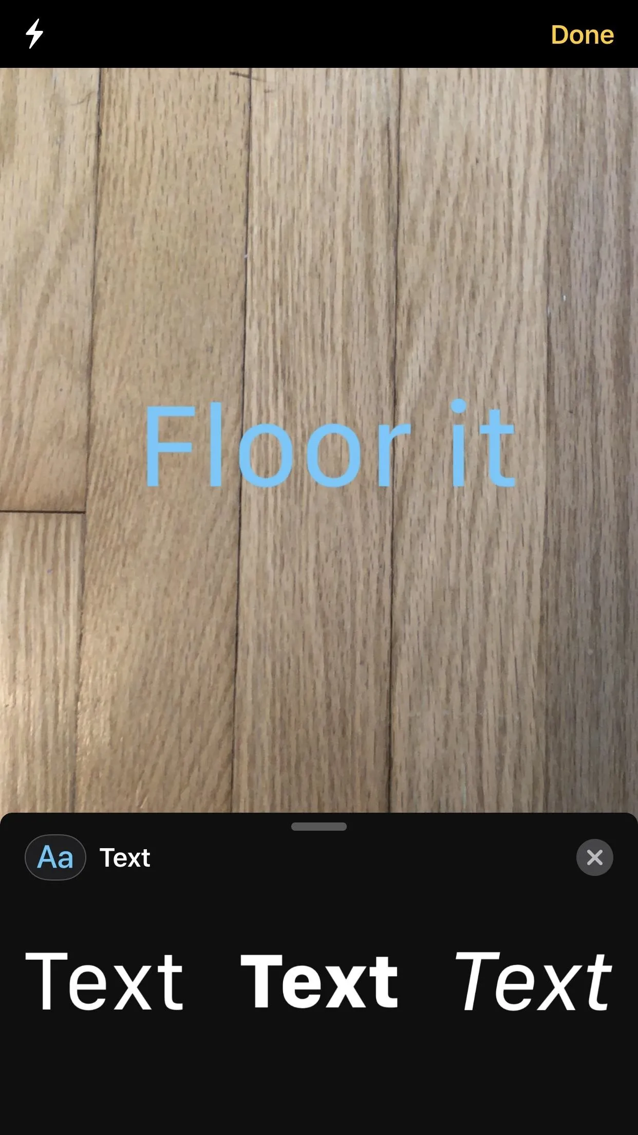 Wooden floor with the text overlay "Floor it" in blue.