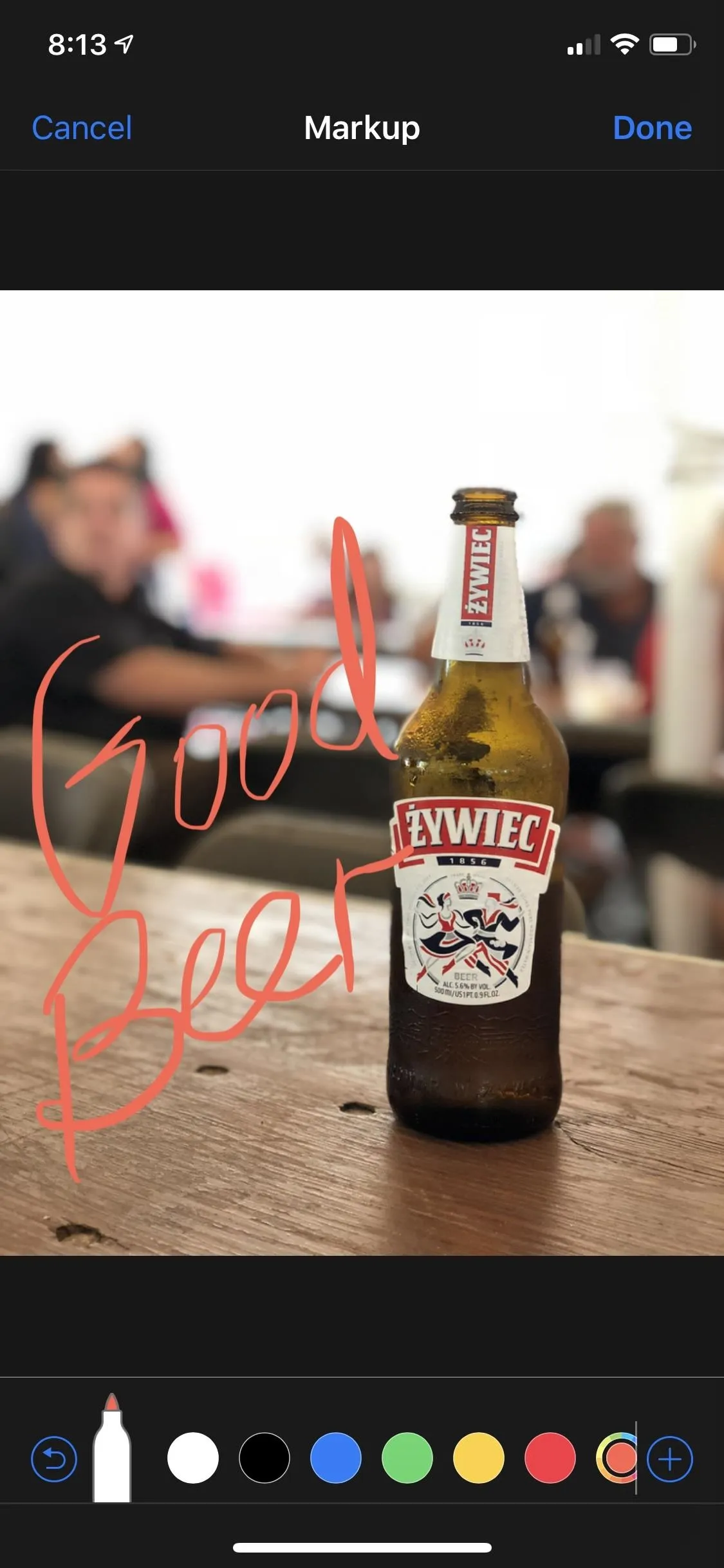 Cold beer bottle on a wooden table.