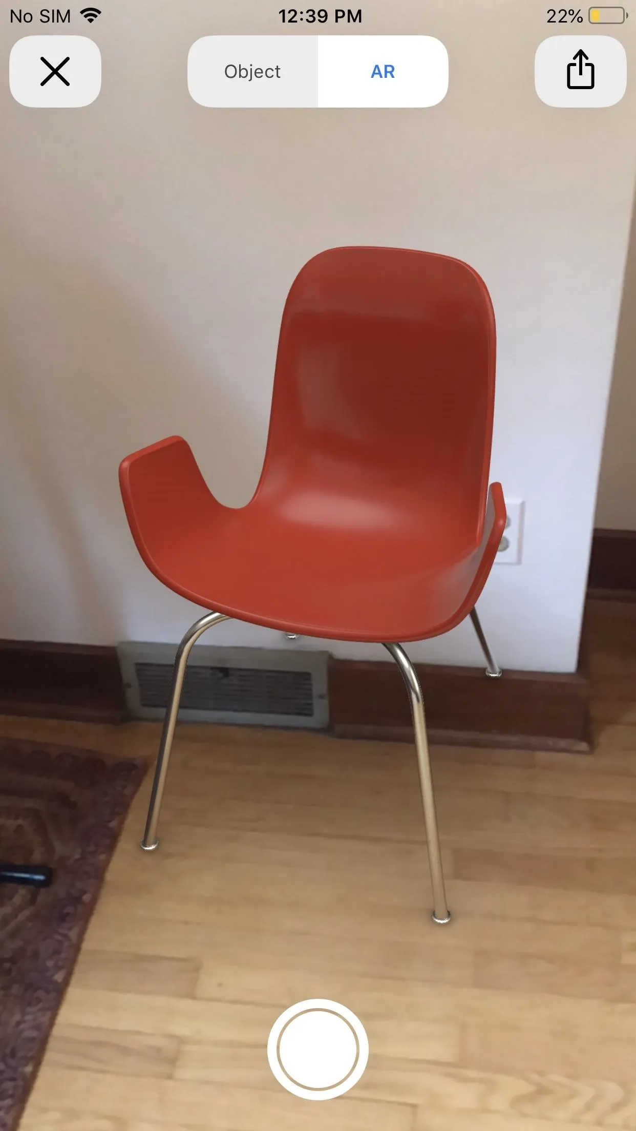 Modern orange chair with metallic legs.