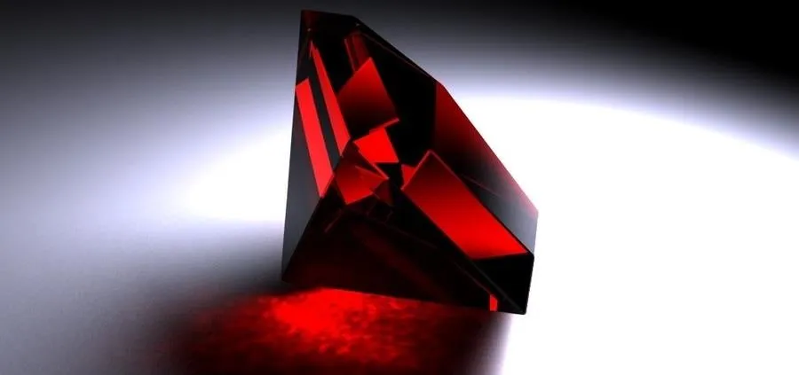 Red gemstone with a reflective surface.