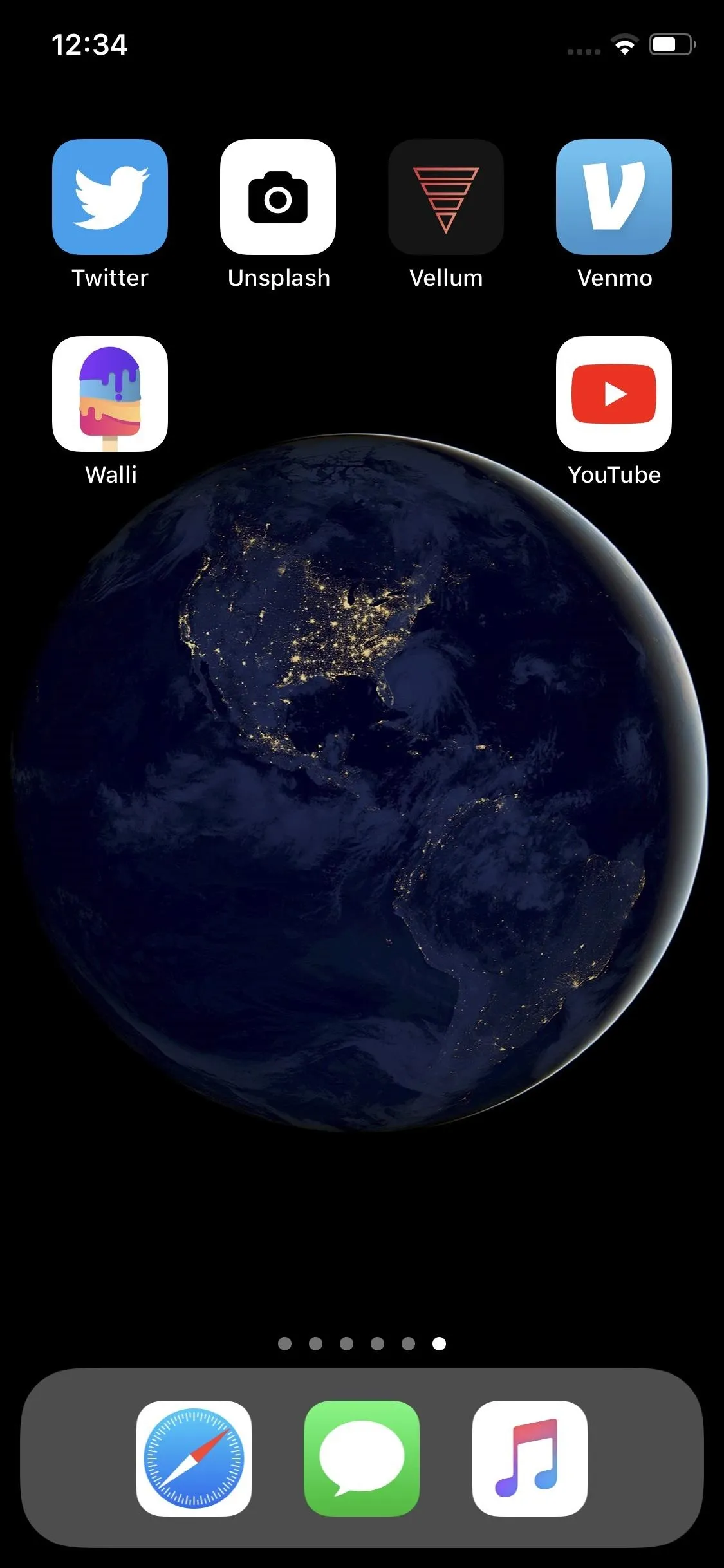 Smartphone home screen displaying a globe background with various apps.