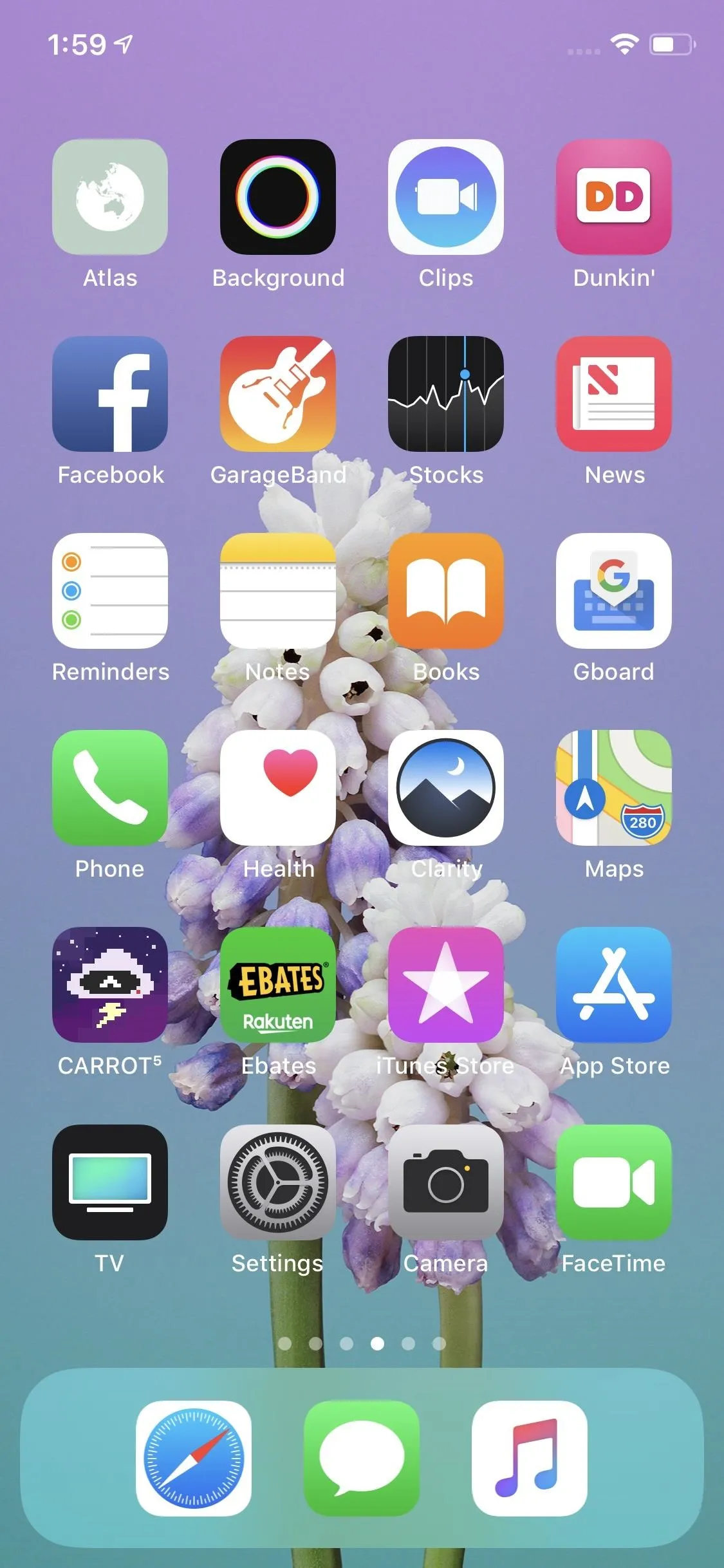 Smartphone home screen displaying various app icons with a floral background.