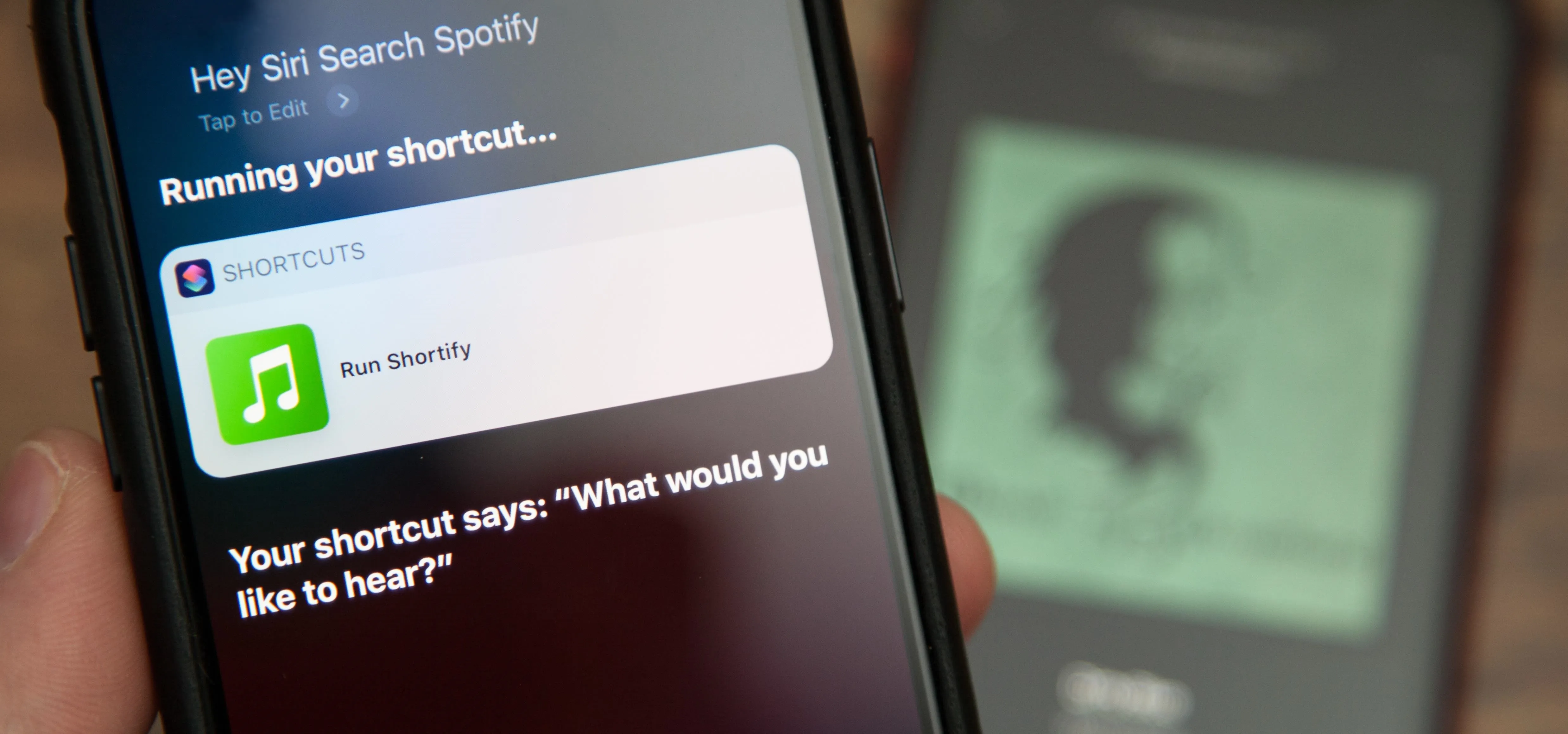 Using a smartphone to activate a music shortcut on Spotify.