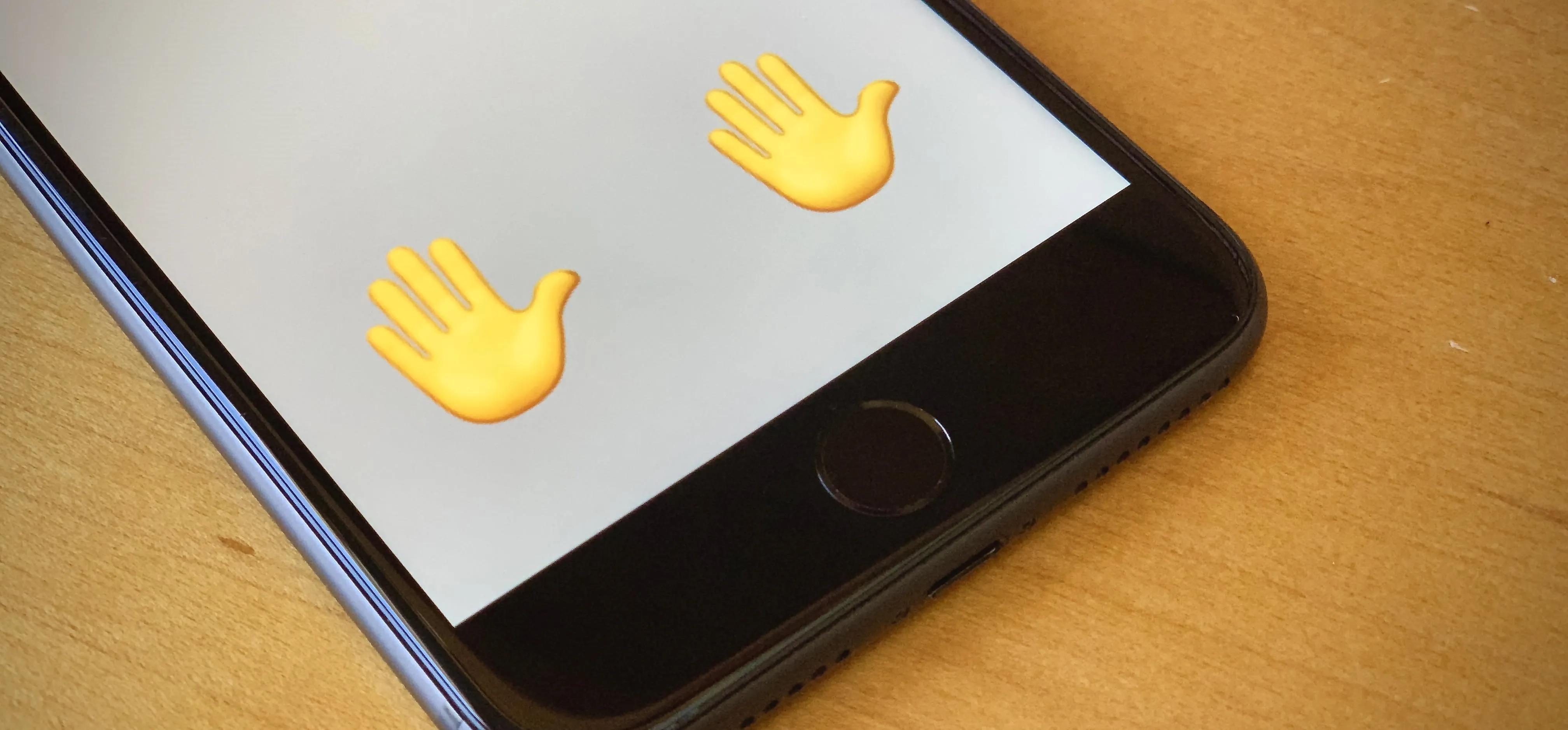 Hand emoji on a smartphone screen.