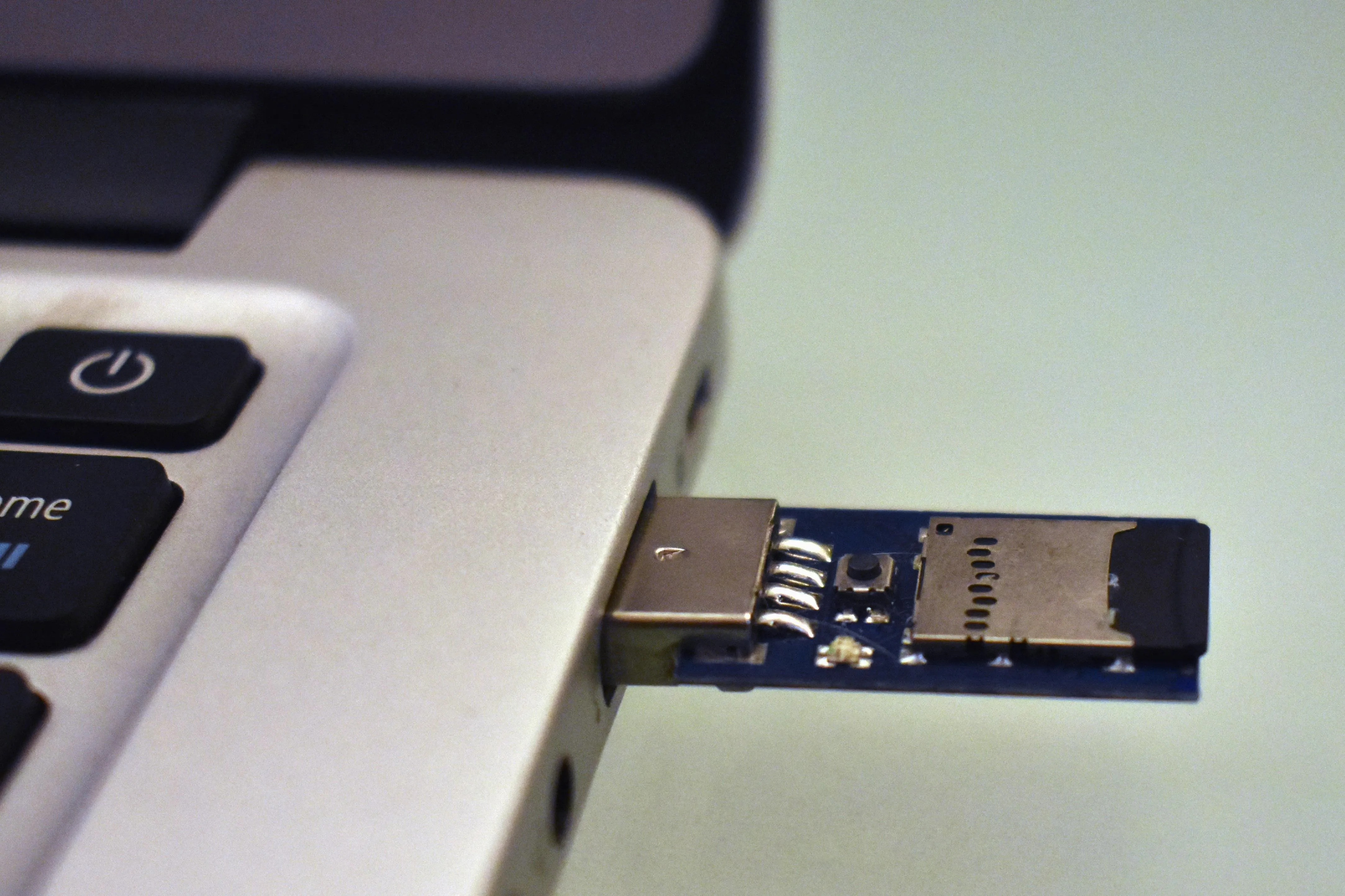 USB flash drive connected to a laptop port.