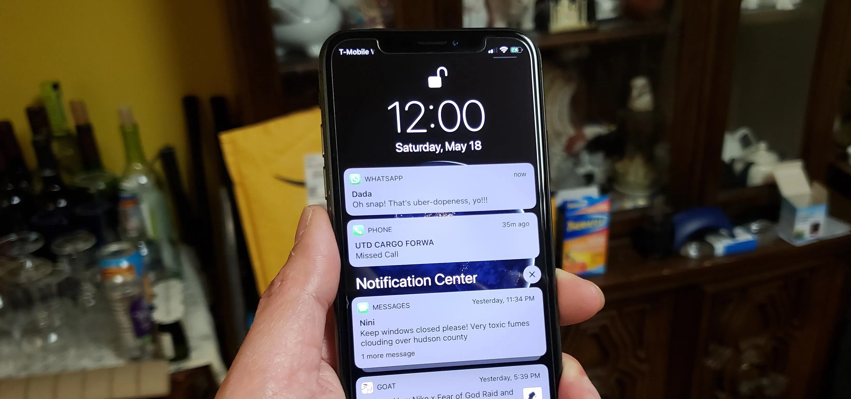 Mobile phone displaying notifications on the lock screen.