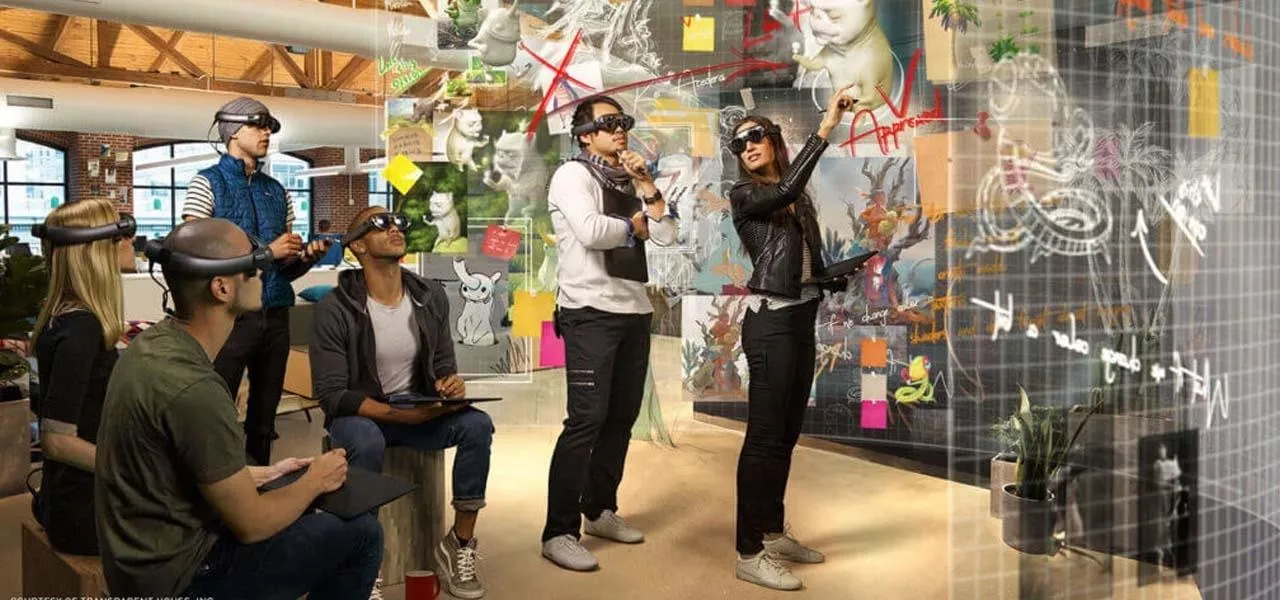 A group of people engaged in a technology-driven collaborative workspace using augmented reality glasses.