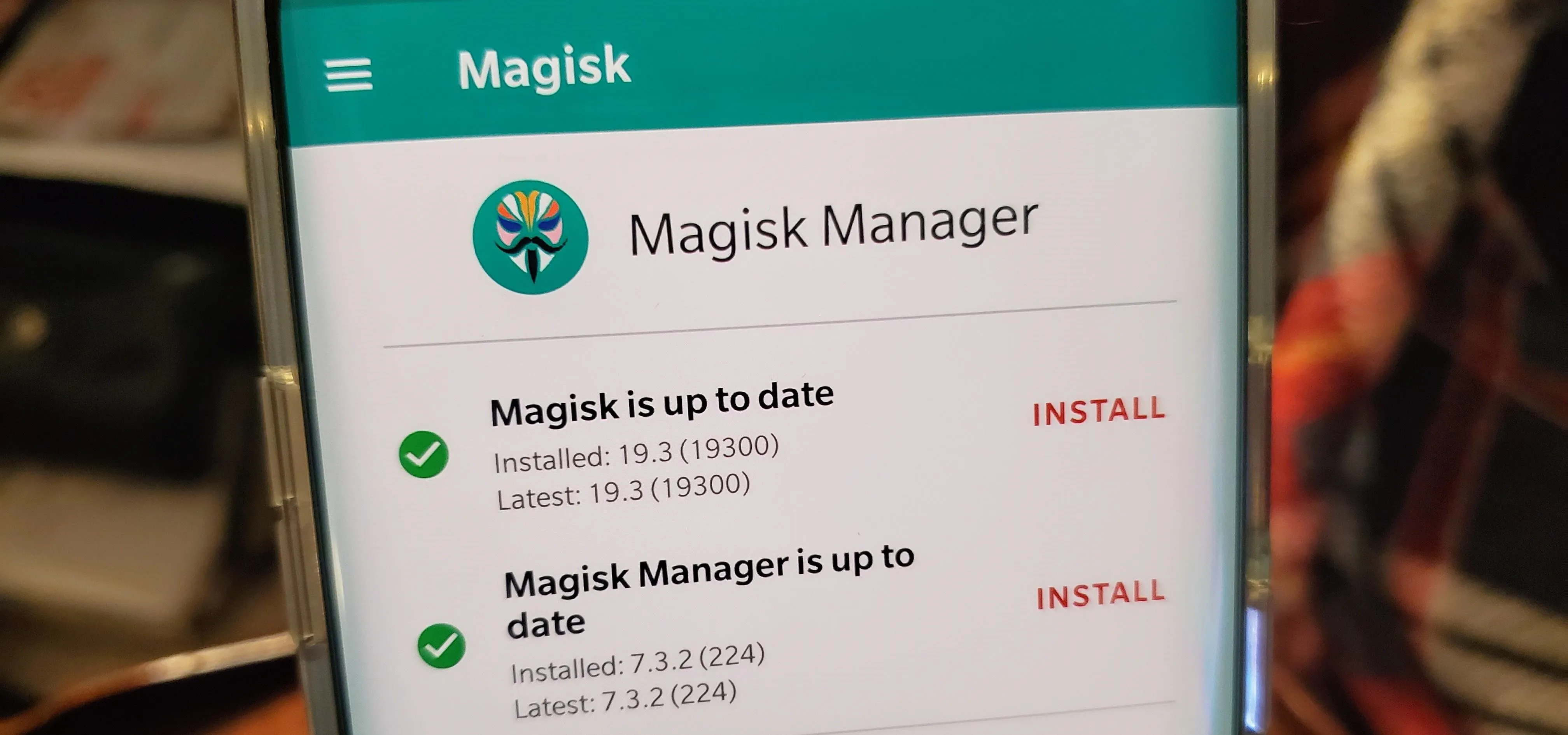 Magisk Manager app showing version information and update status.