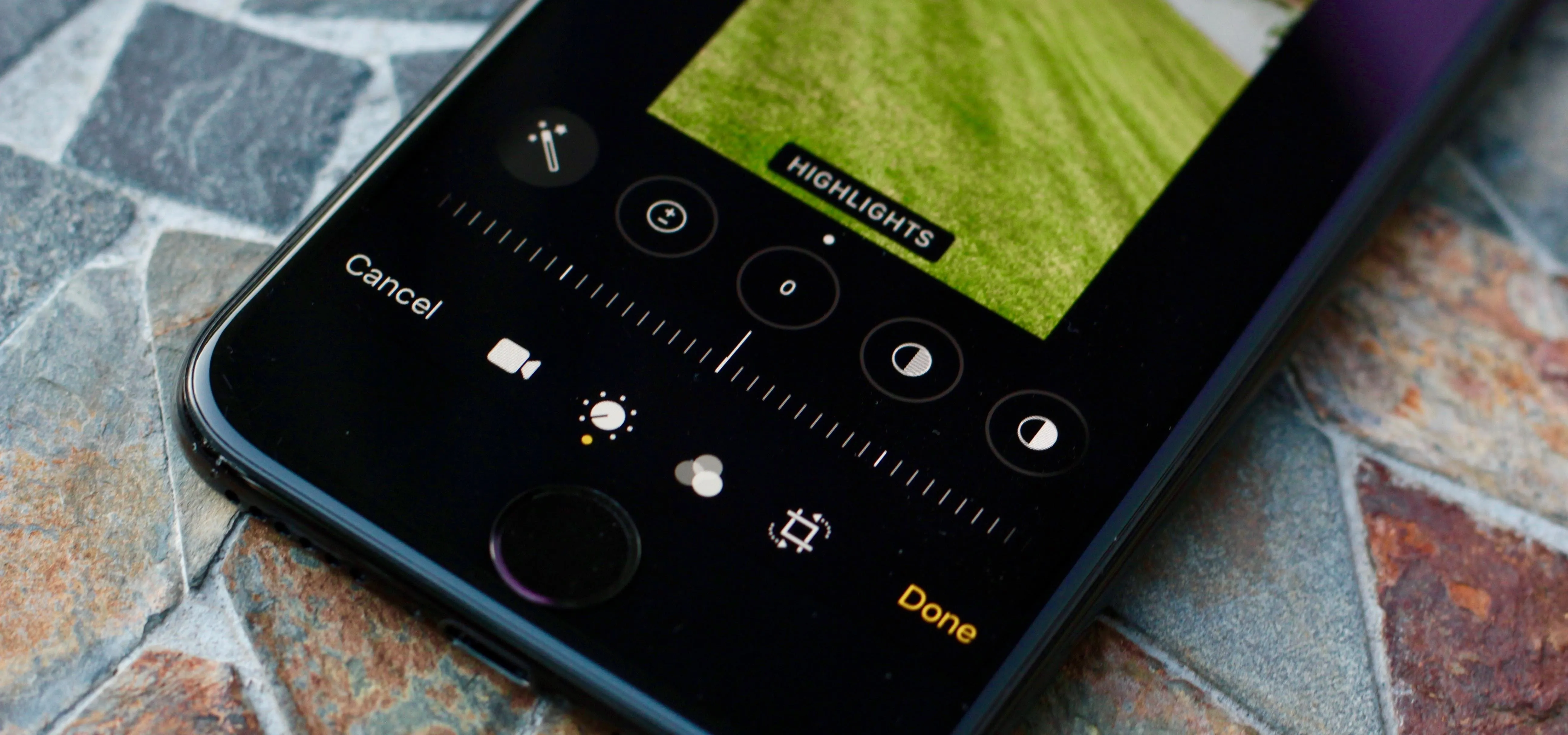 Close-up of a smartphone camera interface featuring photo settings and a preview of a grass field.