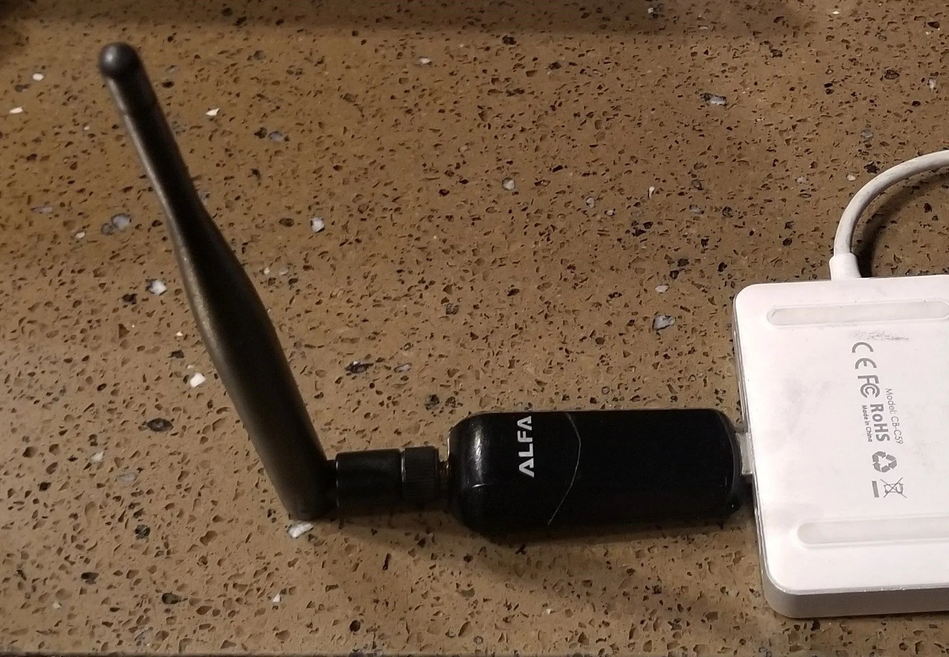 Wireless network adapter with antenna connected to a device.