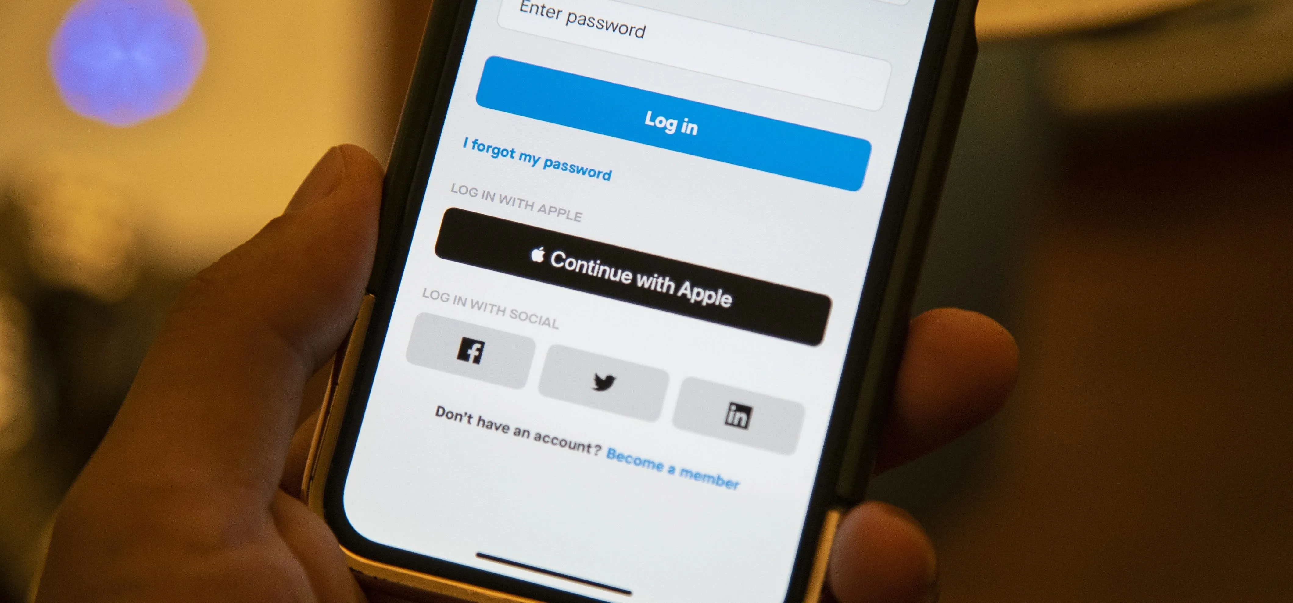 Login screen on a smartphone with options to sign in using Apple, Facebook, and Twitter.