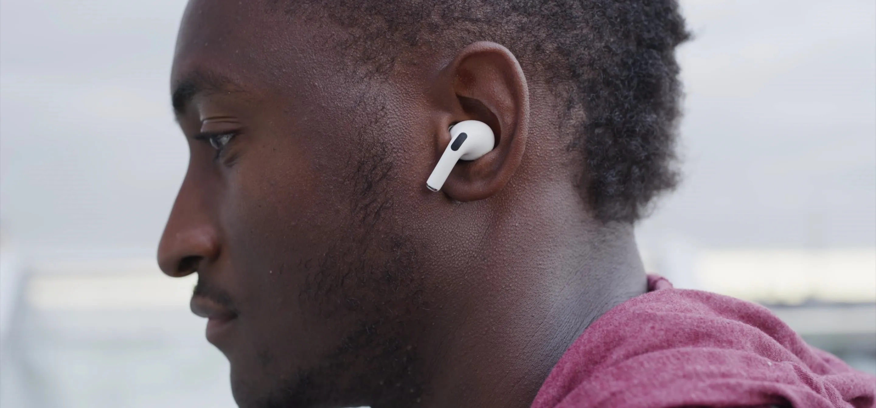 Person wearing wireless earbuds.