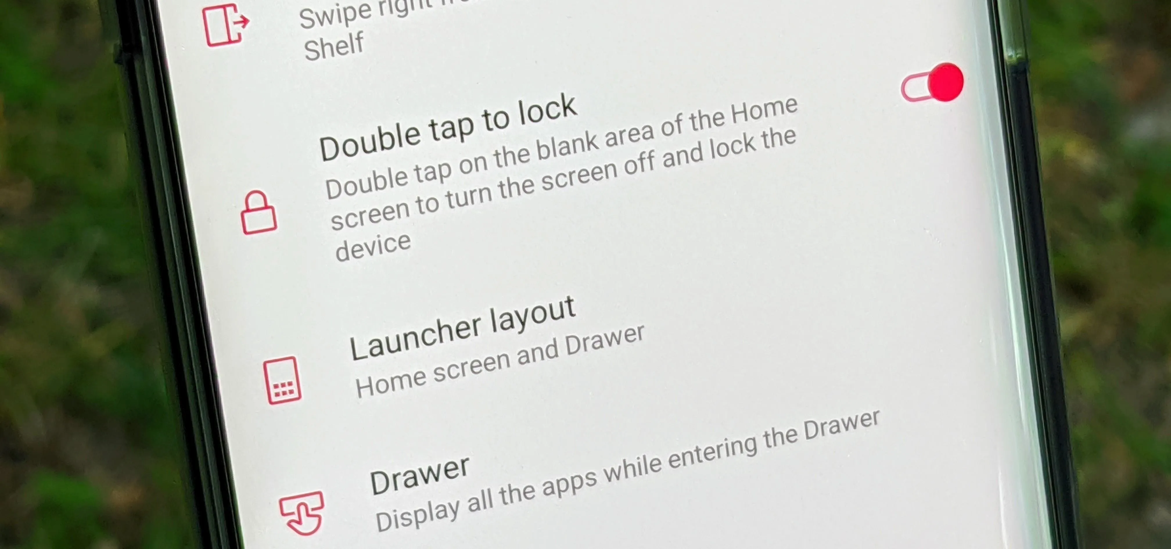 Settings menu on a smartphone displaying options for double tap to lock, launcher layout, and app drawer.